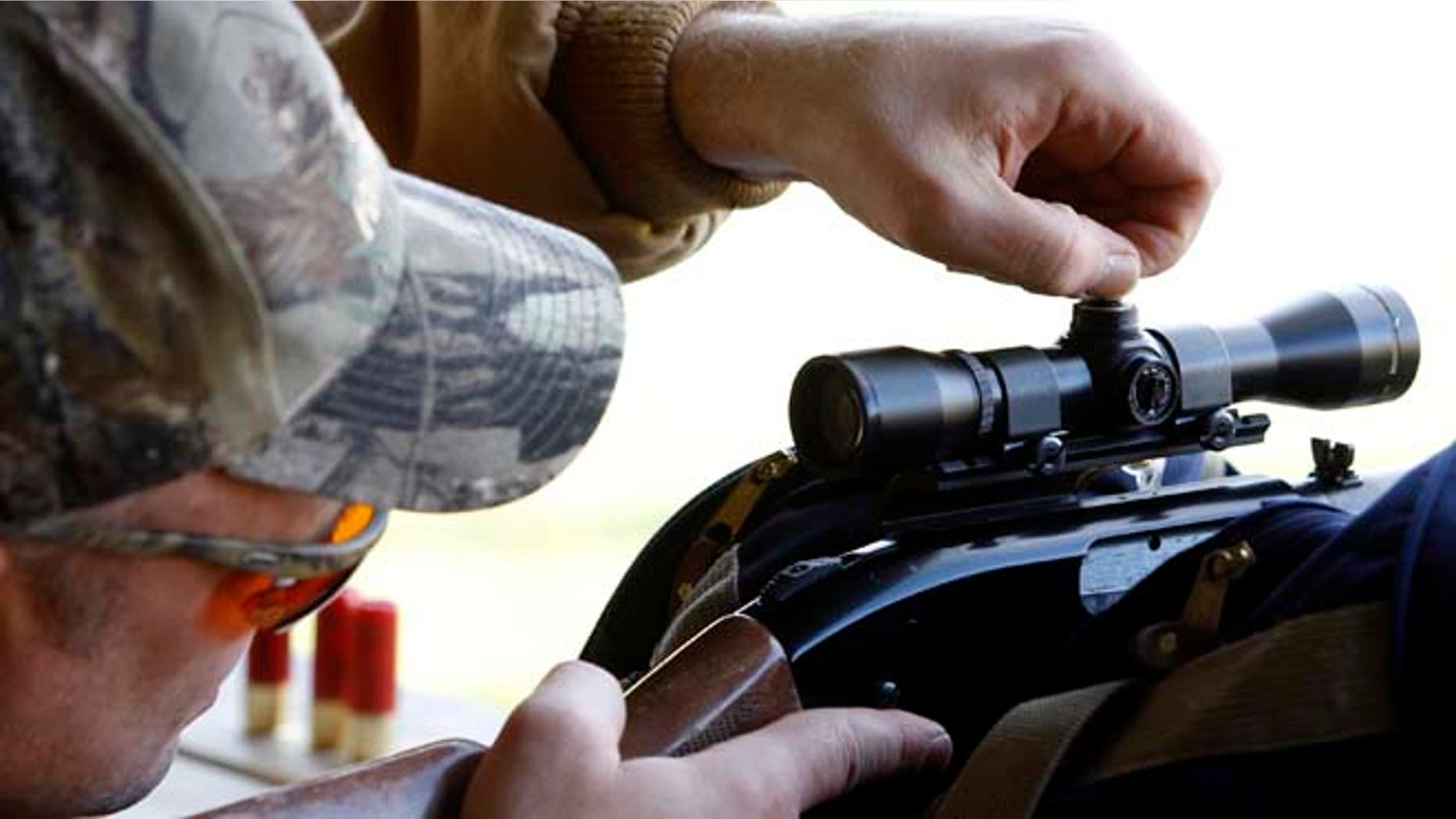 In this file photo, a hunter dials in his scope at a firing range in Joliet, Ill,