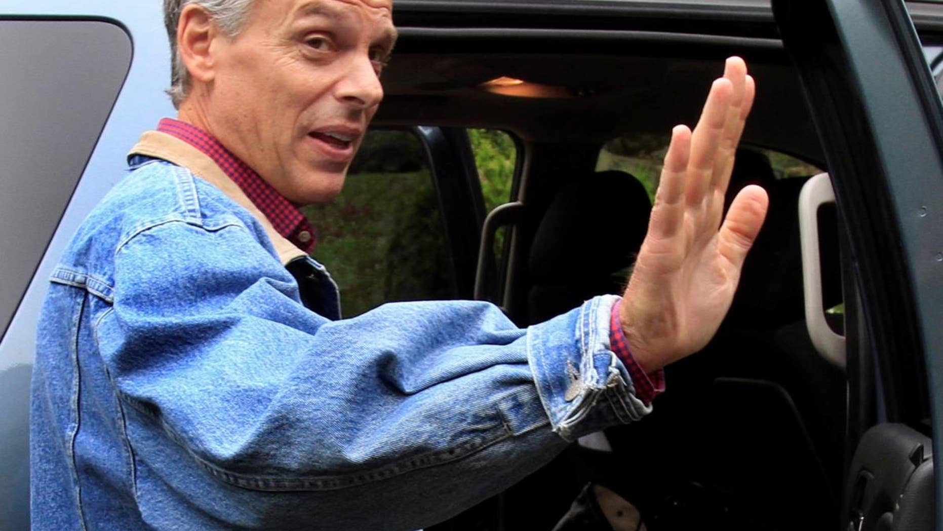 Former Republican Gov. Jon Huntsman, Jr., of Utah waves goodbye after greeting guests at a house party Monday, May 23, 2011 in Durham, N.H.. (AP Photo/Jim Cole)