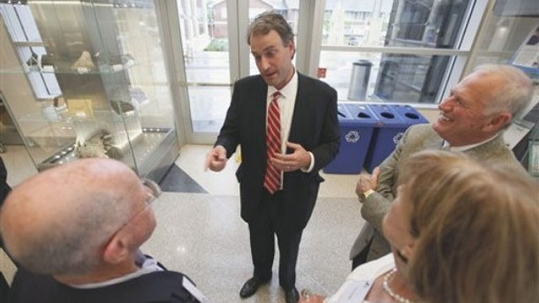 Virginia state Sen. Robert Hurt, center, talks to constituents prior to the start of a dinner at the Virginia Museum of Natural History in Martinsville, Va., July 13. (AP Photo)