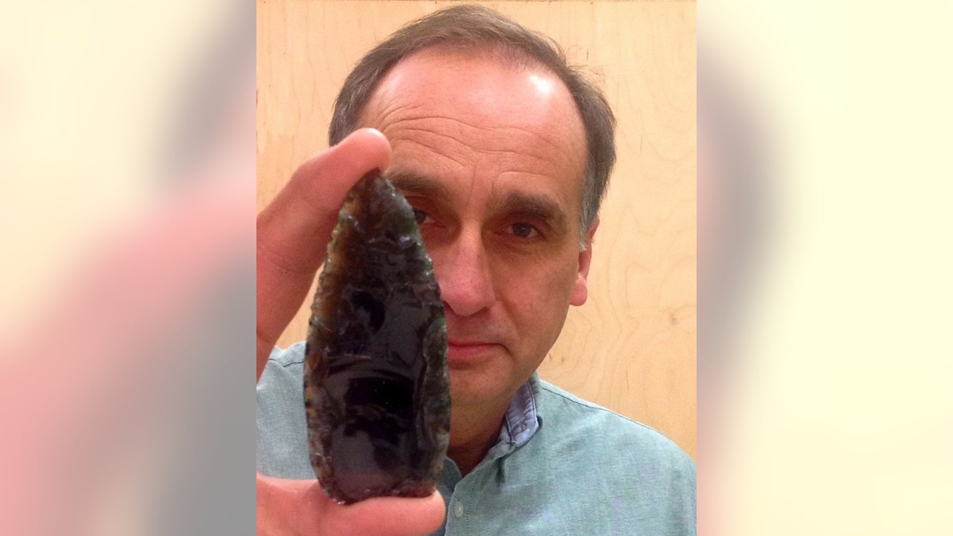 Karl Hutchings, an archaeologist at Thompson Rivers University in Canada, holds a Clovis spear point.