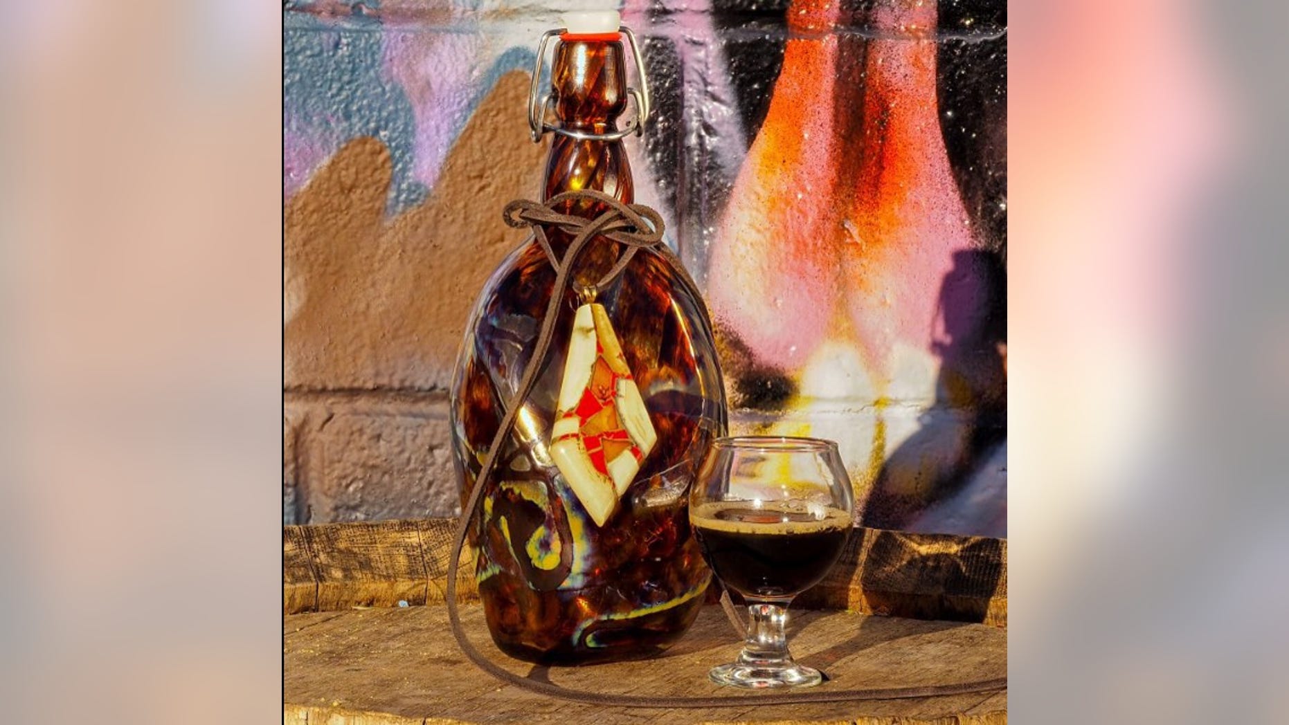 Each bottle of Glacial Mammoth Extinction has a pendant made with prehistoric mammoth tusk and 14K gold.