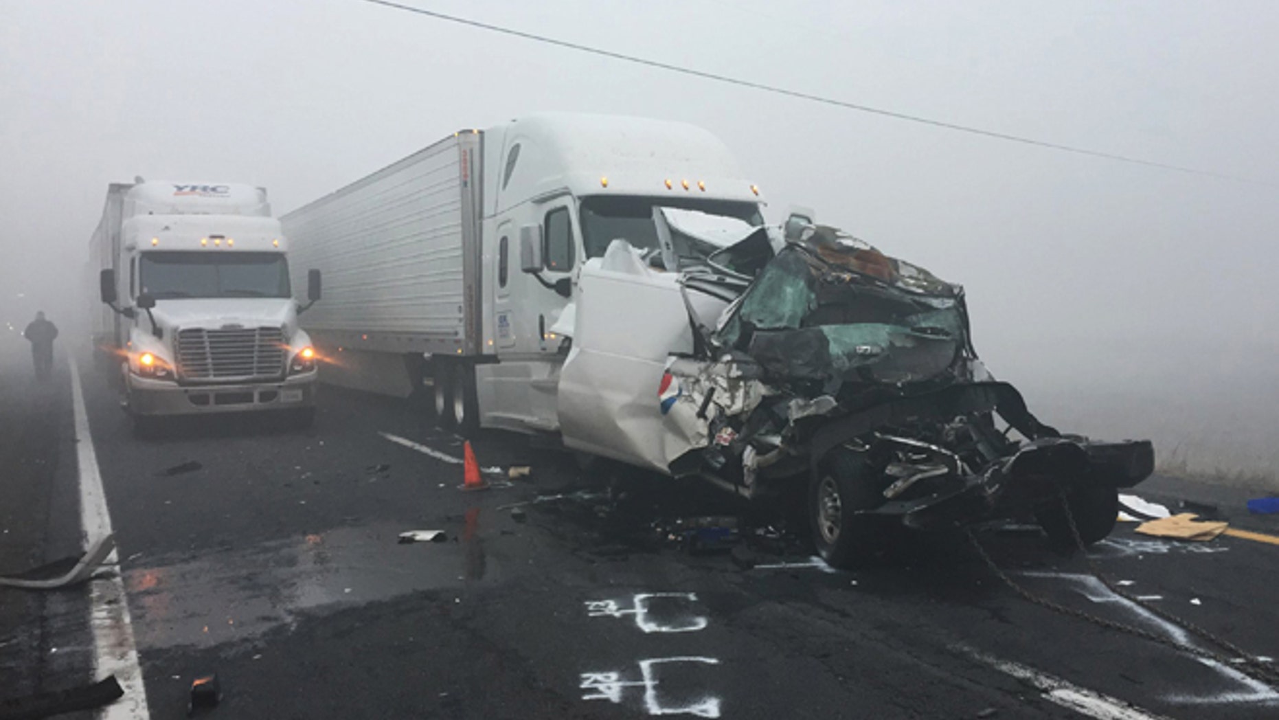 In this photo provided by the Arizona Department of Public Safety, vehicles remain at the scene of a traffic accident along Interstate 40 on Wednesday, Oct. 19, 2016, in northern Arizona near Parks, Ariz. S