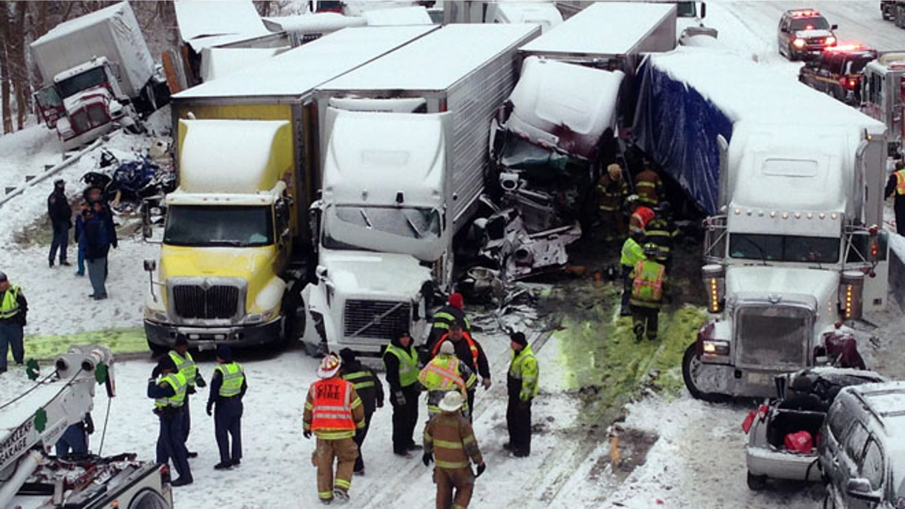 Jan. 23, 2014: In this photo provided by the Indiana State Police, emergency crews work at the scene of a massive pileup involving about 15 semitrailers and about 15 passenger vehicles and pickup trucks along Interstate 94.