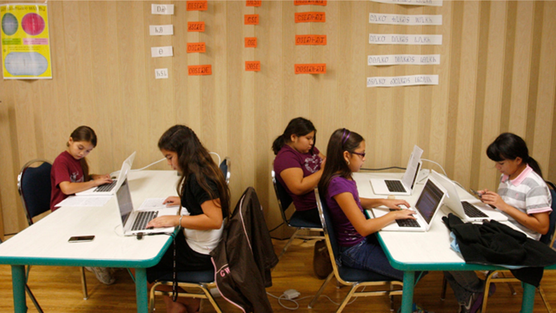 Students work at their computers in a classroom at the Cherokee Nation Immersion School in Tahlequah, Okla. Nearly two centuries after a Cherokee silversmith named Sequoyah developed a system of symbols for each syllable spoken by the Cherokee, the tribe's written language has become available on iPhone and iPods.