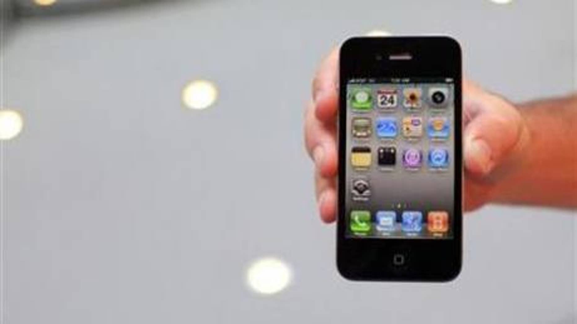 June 24: A customer displays an iPhone 4 purchased at the Apple Store 5th Avenue in New York.