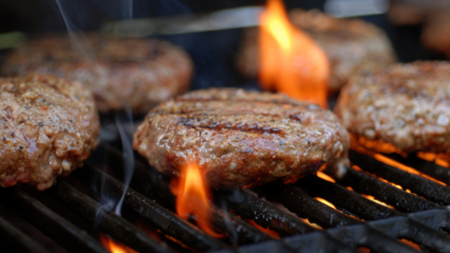Hamburgers being flame broiled on the gas grill
