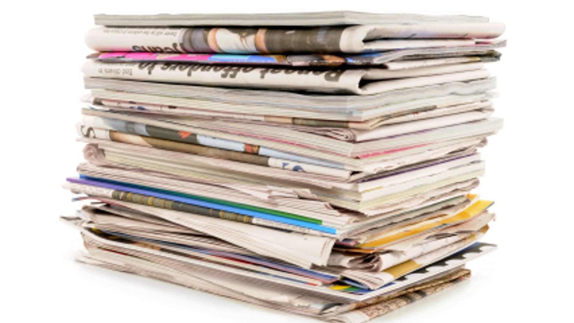 Pile of old newspapers and magazines against a white background