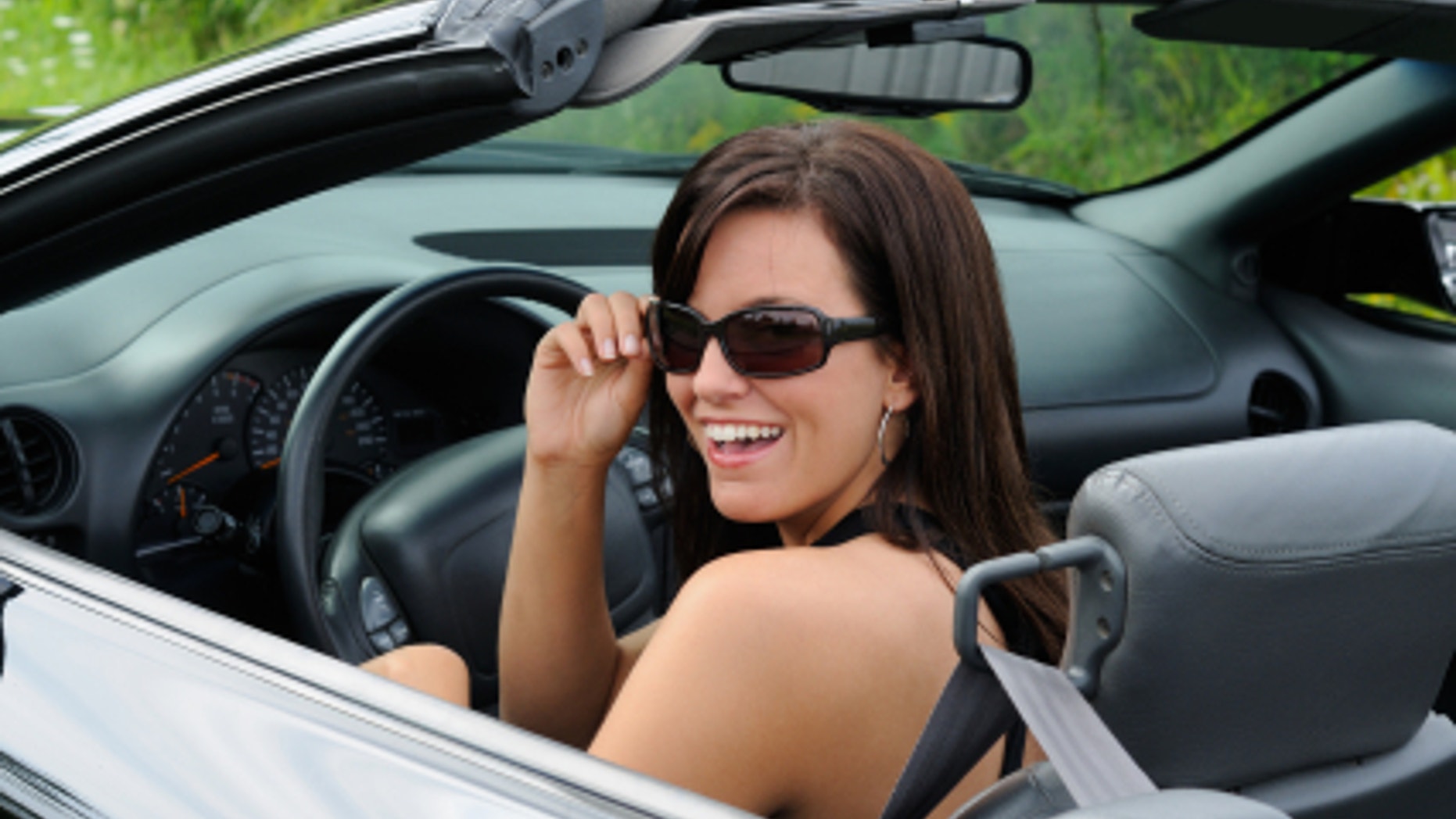 Beautiful Brunette Young Woman Driving A Sports Car