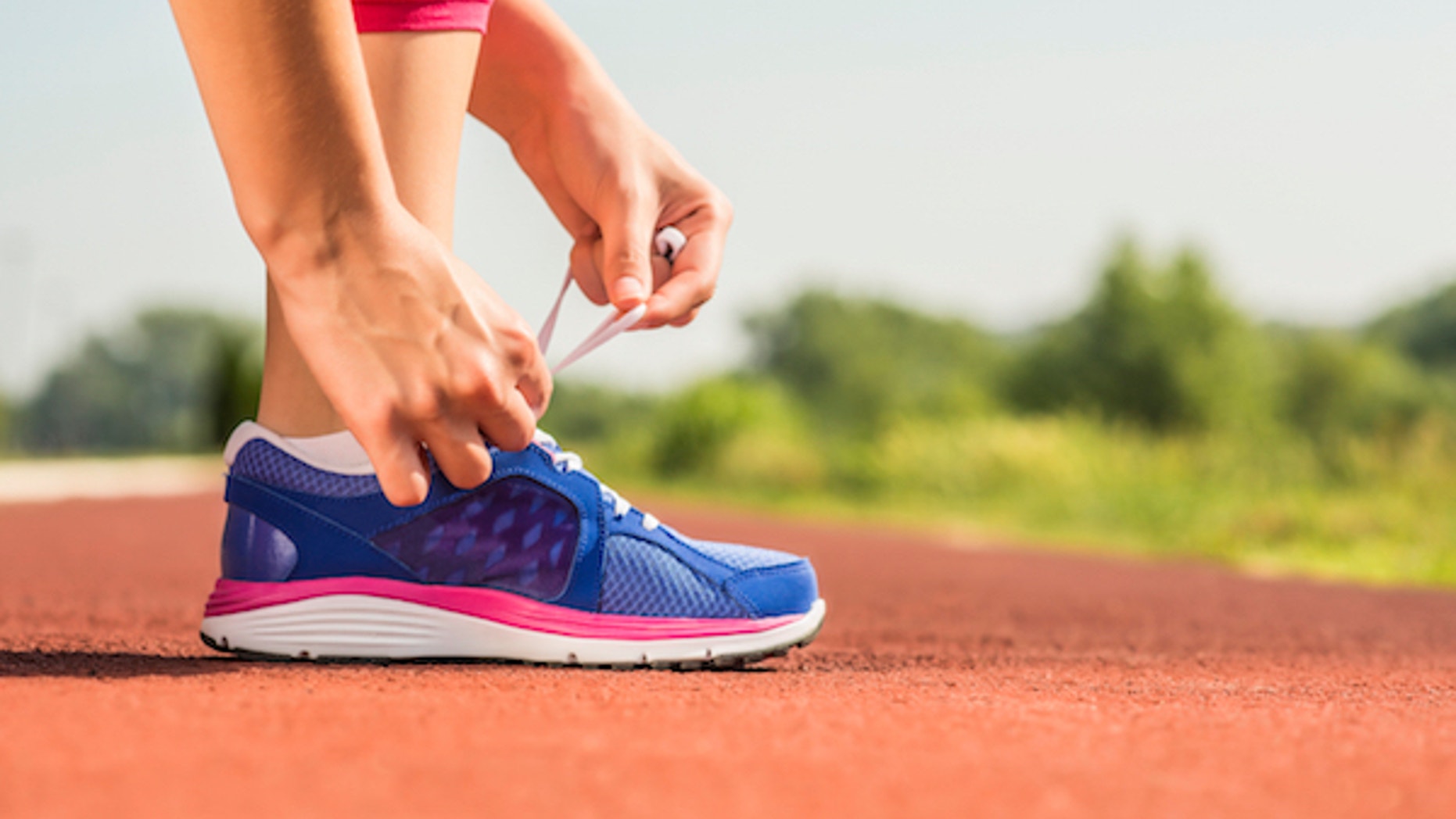 tying shoes at starting line