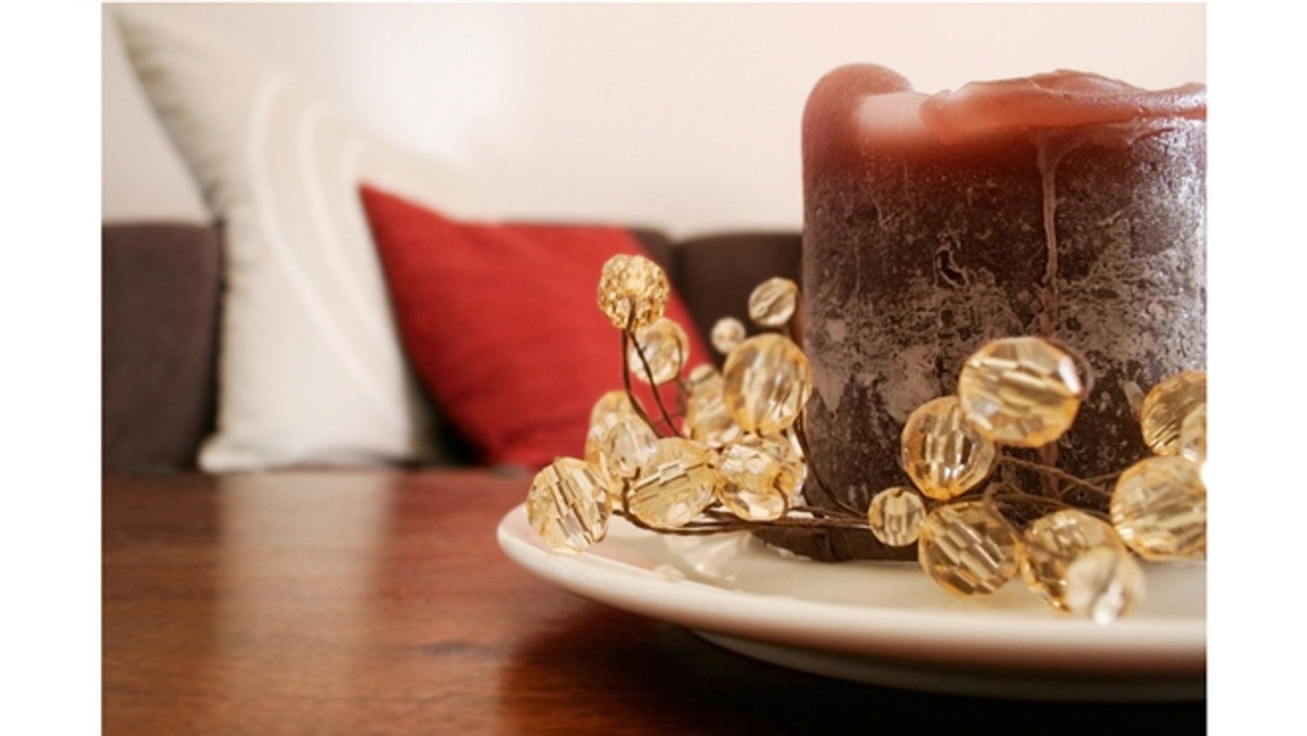 Brown candle with glass bead decorations.