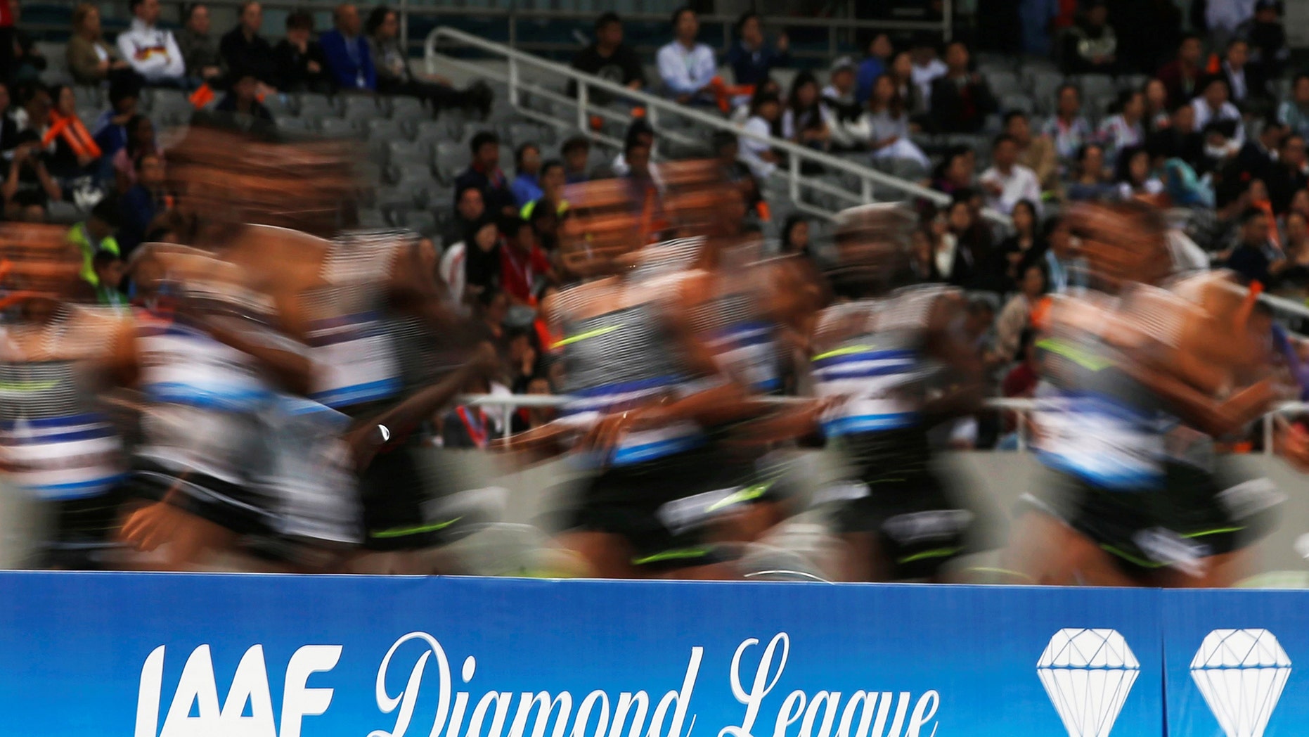 File photo - Athletes run past a Diamond League board during an IAAF Athletics Diamond League meeting in Shanghai Stadium, Shanghai, China on May 14 2016 (REUTERS/Aly Song).