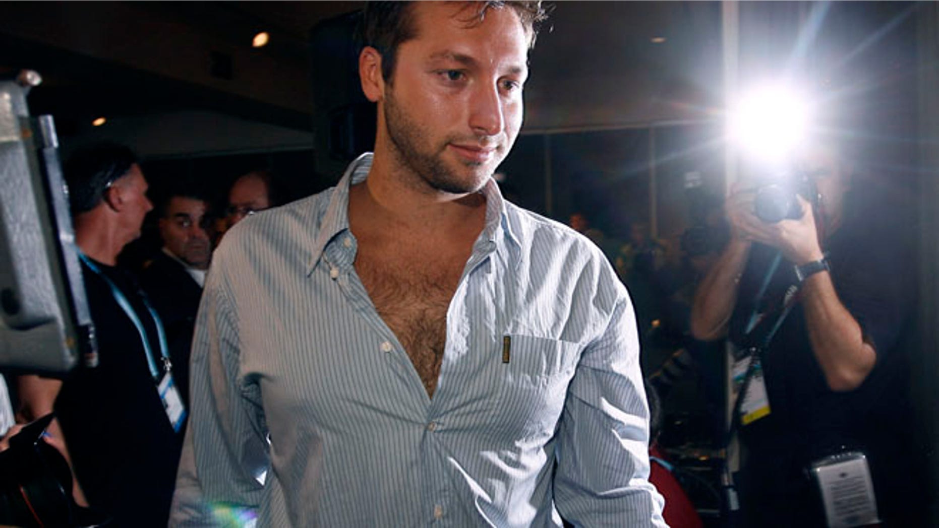 FILE:Photographers surround five-times Olympic champion Ian Thorpe of Australia after a news conference in Melbourne.