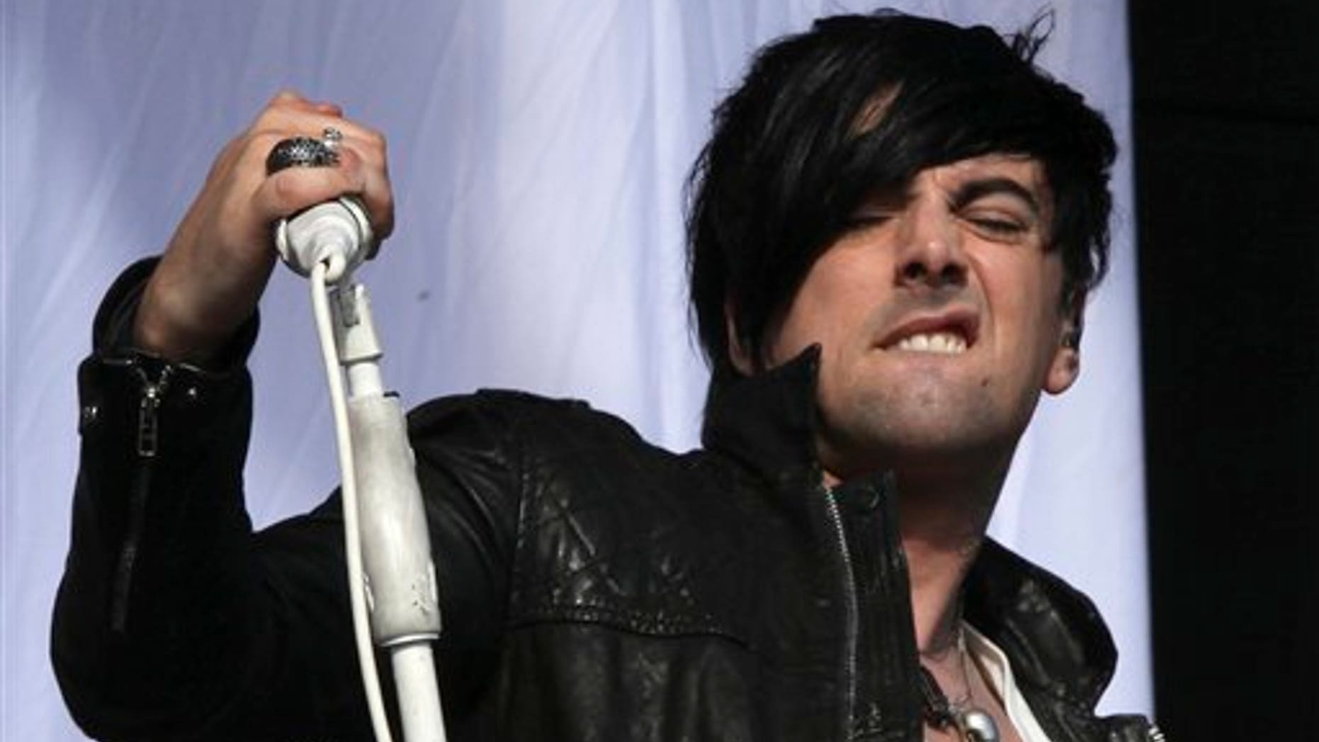 FILE - This is a Saturday, Aug 20, 2011 file photo of British musician Ian Watkins, lead singer of Lostprophets, as he performs on stage at V Music Festival in Hylands Park, Chelmsford, England Watkins pleaded guilty on Tuesday Nov. 26. 2013 to a series of sexual offenses, including trying to rape a baby. Watkins, 36, was arrested last December and charged with more than 20 offenses, including raping a baby, conspiring to sexually assault a child and and making indecent images. (AP Photo/Joel Ryan, File)