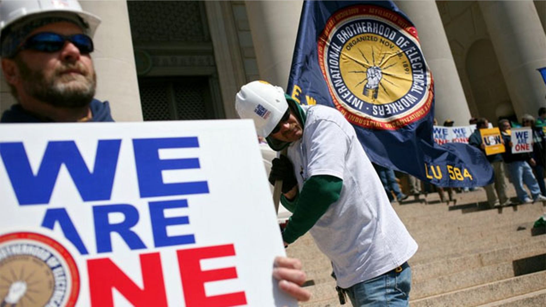 FILE: Members of the International Brotherhood of Electrical Workers join other union workers and supporters during a rally in Oklahoma.