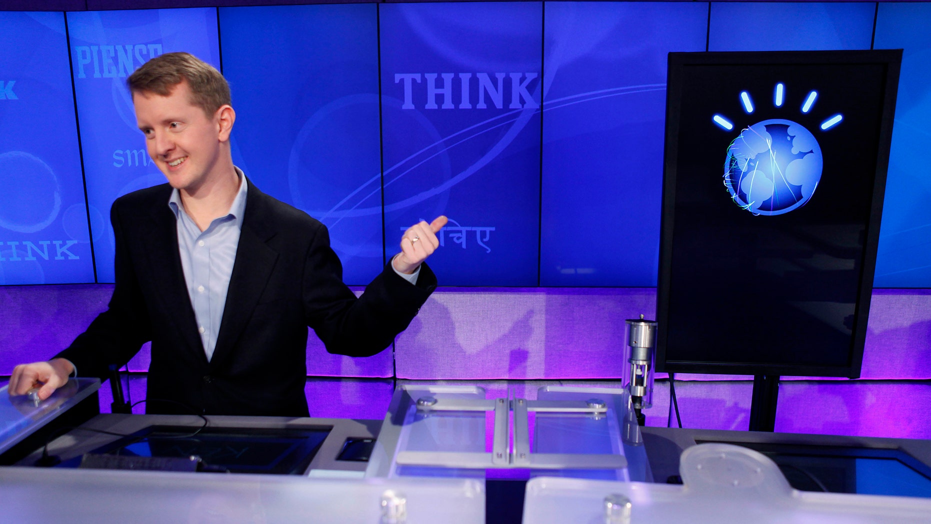 FILE - In this Thursday, Jan. 13, 2011, file photo, "Jeopardy!" contest Ken Jennings, who won a record 74 consecutive games, refers to his opponent, an IBM computer called "Watson," while being interviewed after a practice round of the quiz show in Yorktown Heights, N.Y. Seven years after Watson beat two human quizmasters on a Jeopardy! challenge, the tech industry has pumped resources into training its machines to get even better at amassing knowledge and answering questions. (AP Photo/Seth Wenig, File)