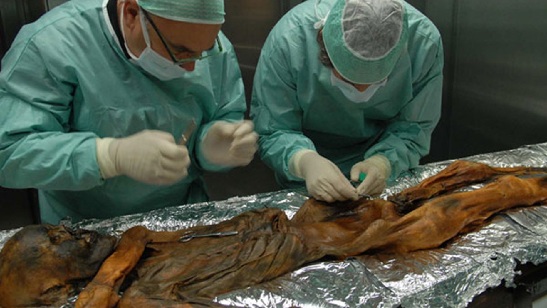 Dr. Eduard Egarter-Vigl (left) and Dr. Albert Zink (right) taking a sample from the Iceman in November 2010.