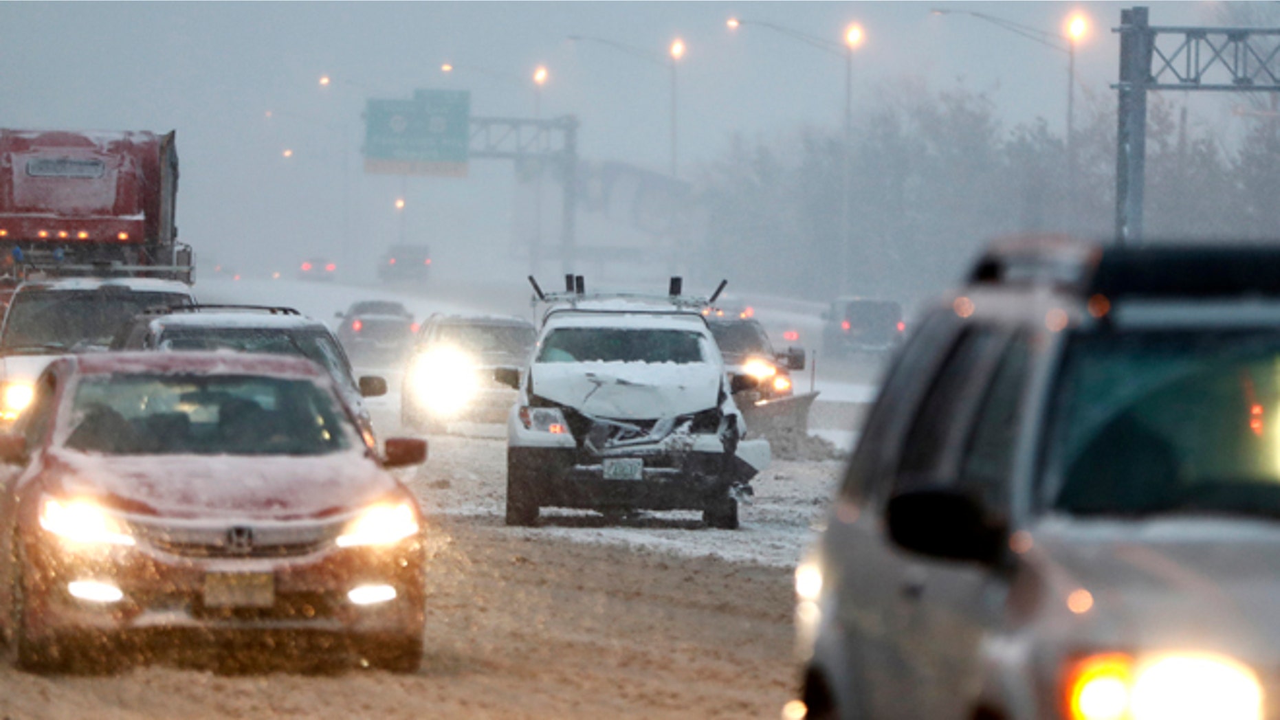 A vehicle involved in a crash sits on the fast lane of Highway Interstate 80 after an accident during a snowfall, Saturday, Dec. 17, 2016, in Lodi, N.J.