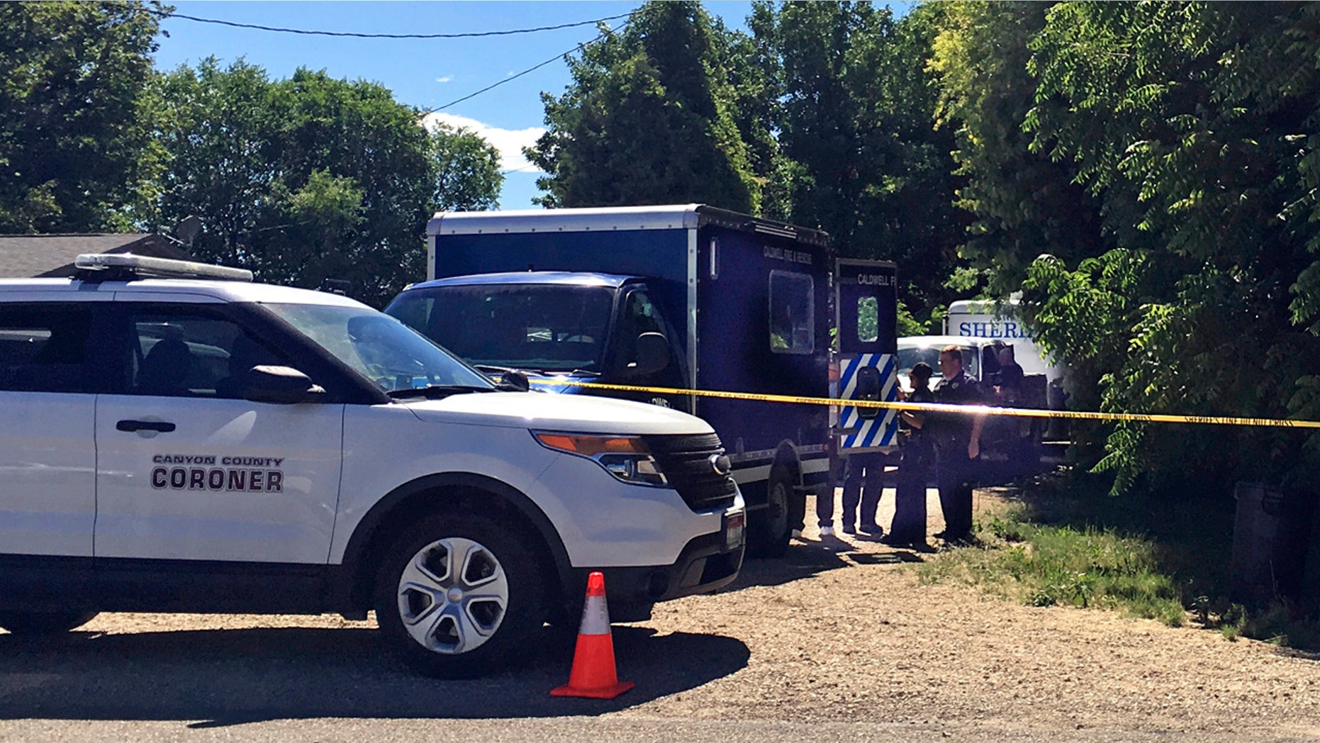 Authorities investigate a scene in Caldwell, Idaho, on Monday, June 19, 2017. Police say three people were found dead inside a home and the Canyon County Sheriff's office is investigating the deaths as possible homicides.