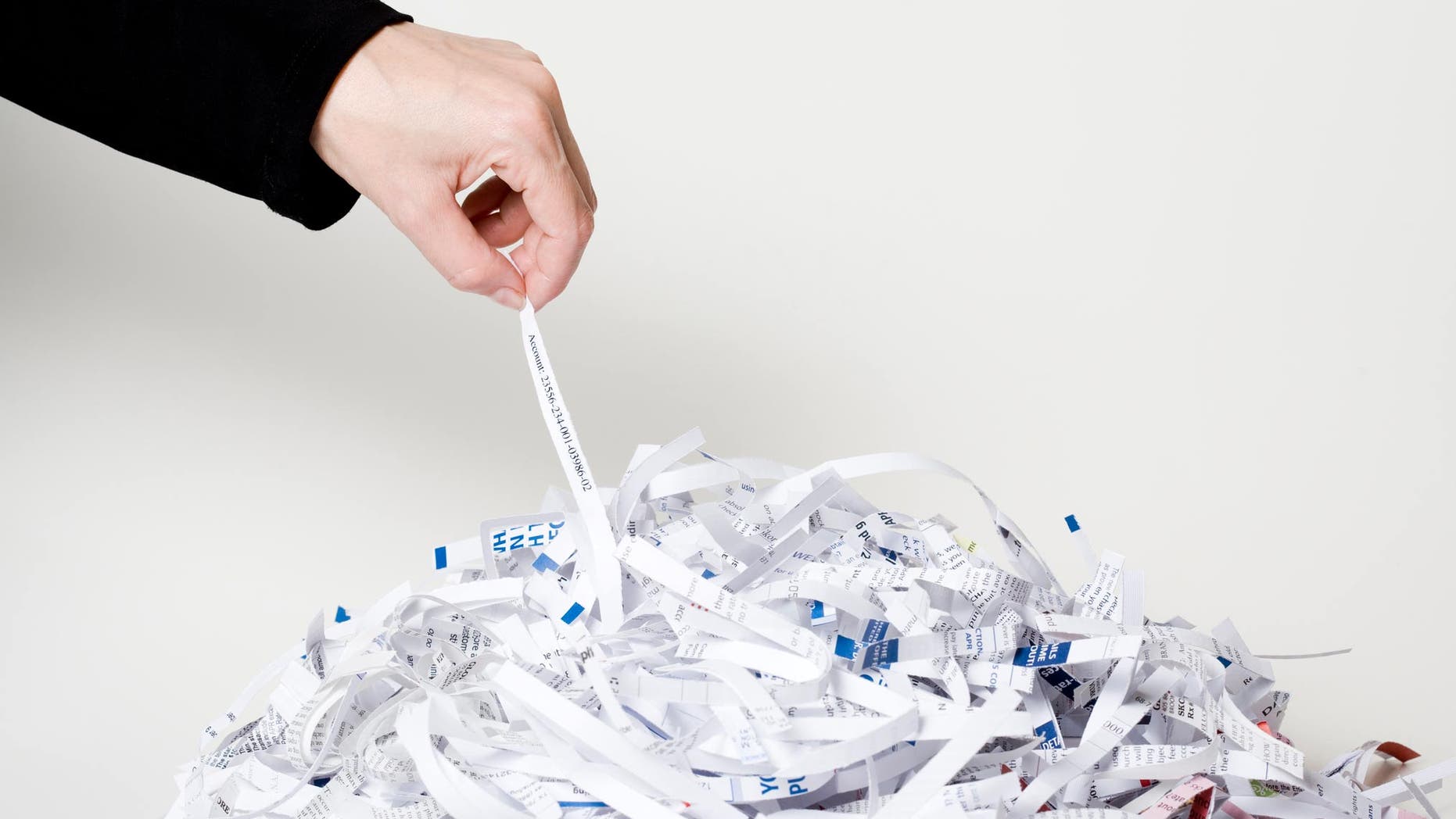 identity thief going through shredded documents
