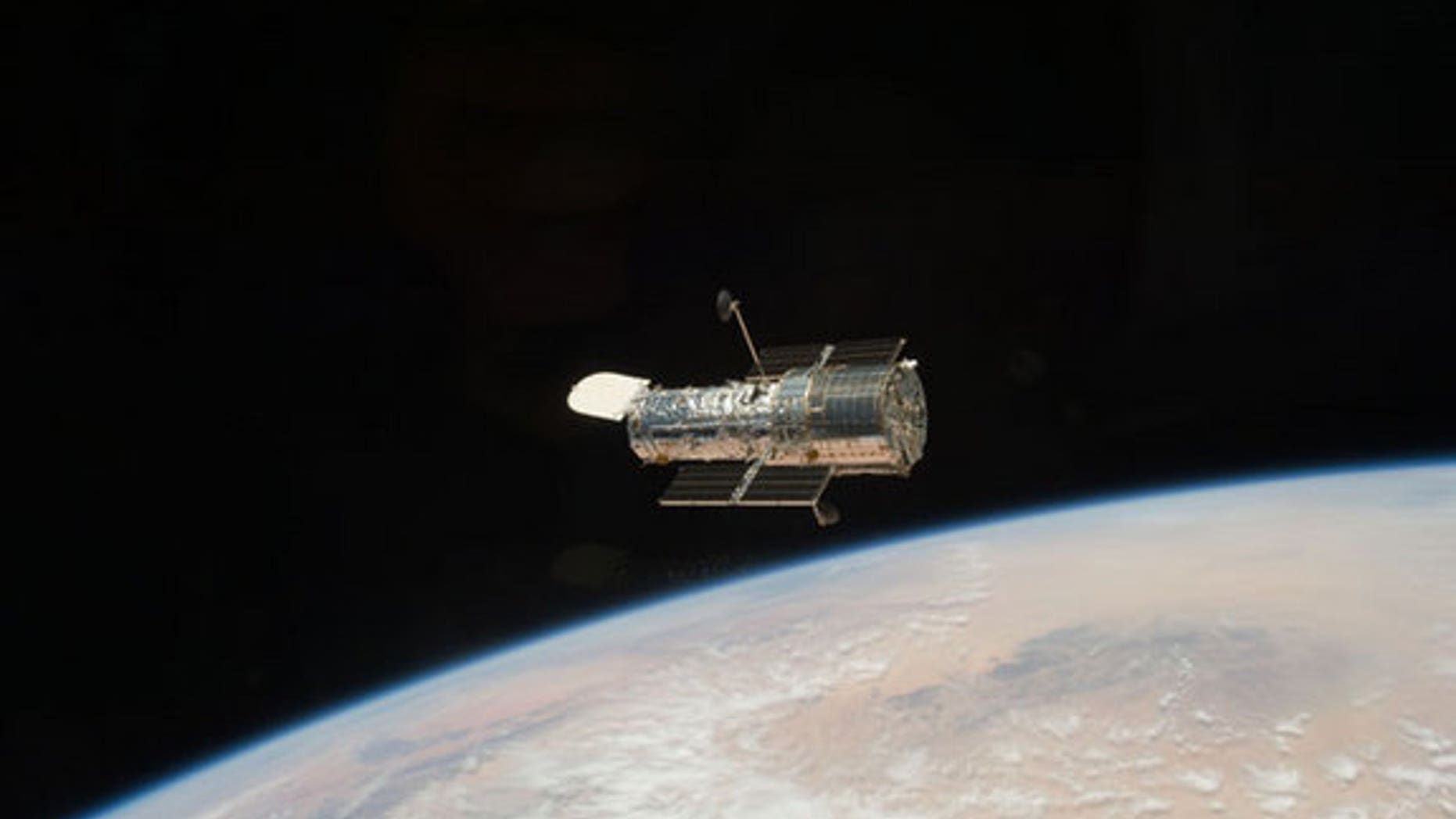 The Hubble Space Telescope got one last overhaul in May 2009 by NASA astronauts on the space shuttle Atlantis and has been sending home stunning new photos ever since. Seen here, the iconic space telescope orbits high above the Earth, after it