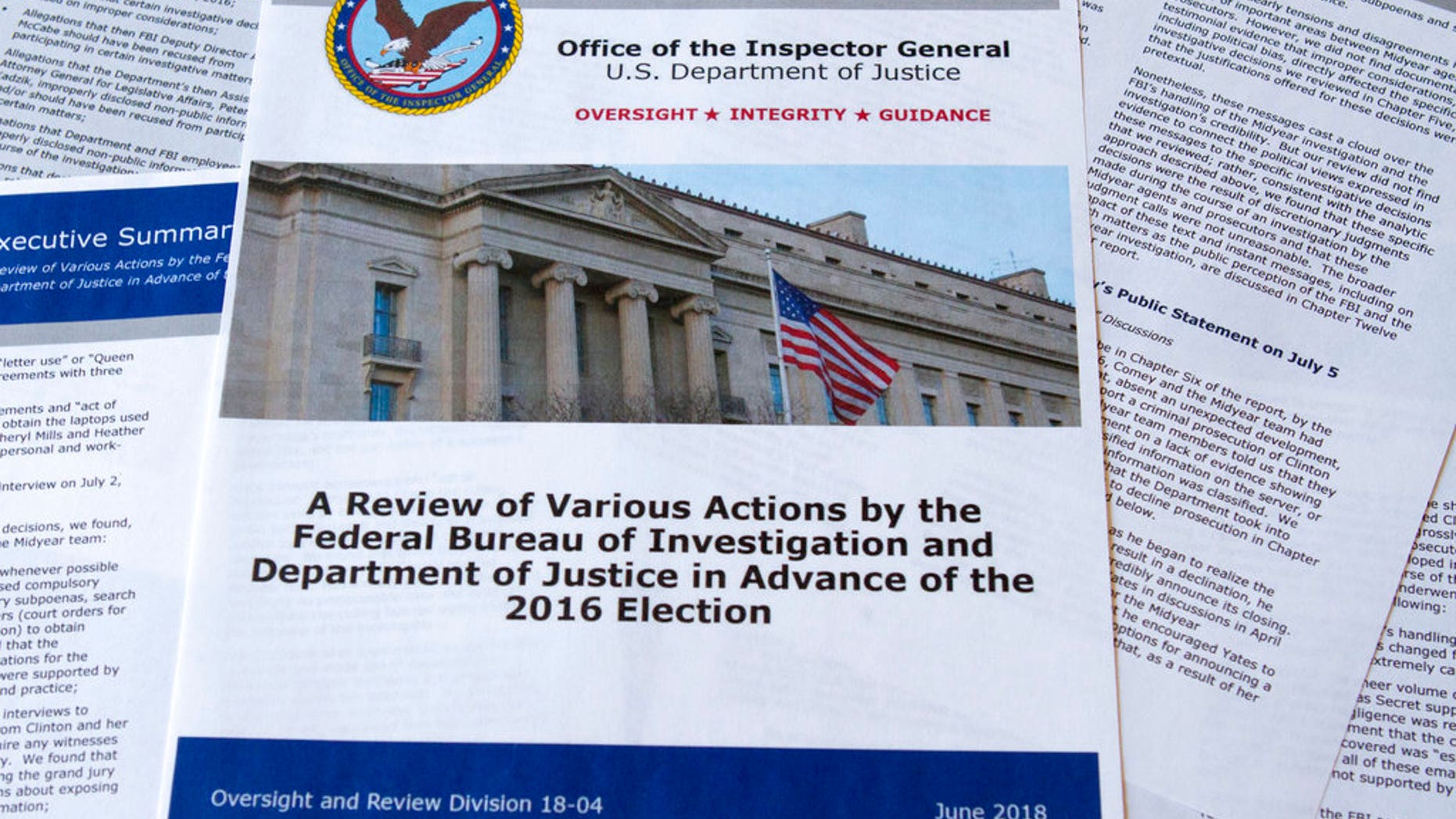 Part of the the Department of Justice Inspector General's report after its release in Washington, Thursday, June 14, 2018. The report documented in painstaking detail one of the most consequential investigations in modern FBI history and revealed how the bureau, which for decades has endeavored to stand apart from politics, came to be entangled in the 2016 presidential election.(AP Photo/Jon Elswick)
