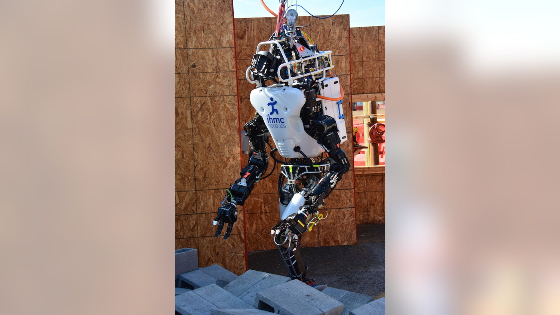 Florida's Institute of Human and Machine Cognition team robot, Running Man, makes its way over a field of rubble during a test event.