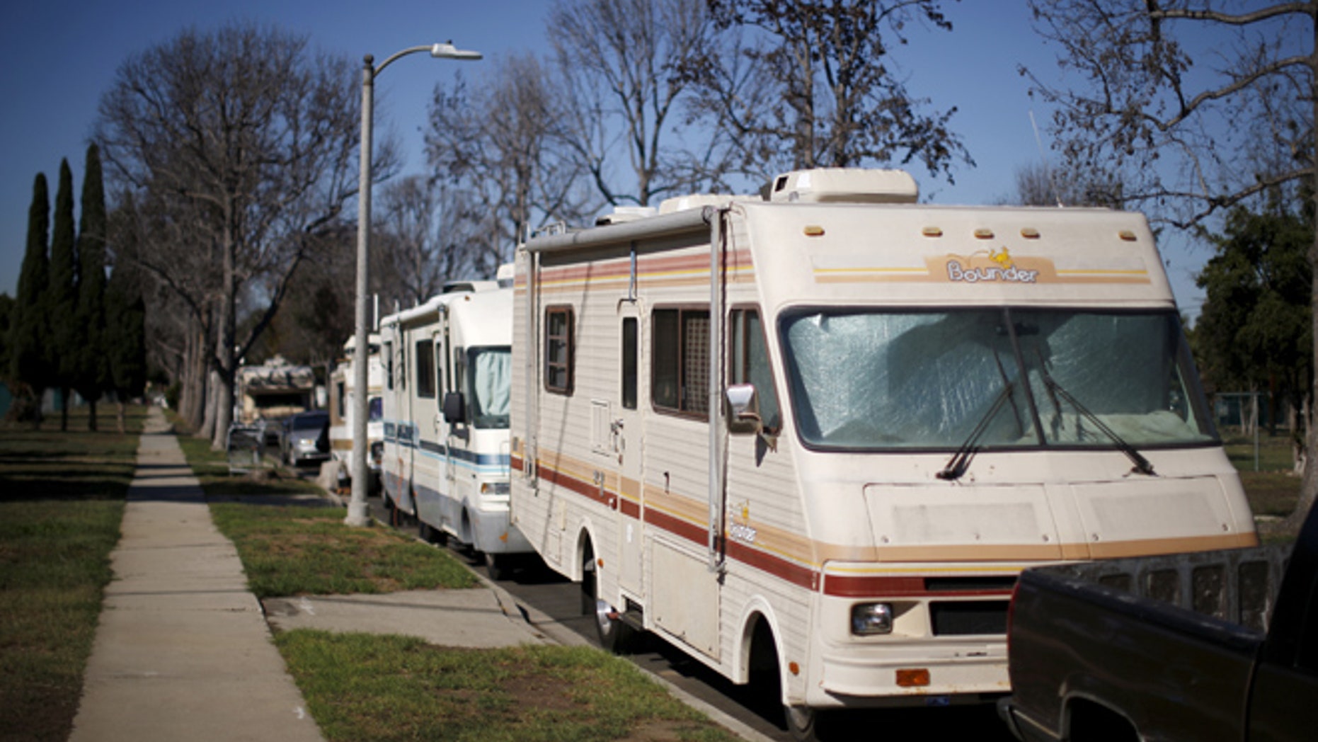 Motorhomes line the street in a homeless motorhome and tent encampment near LAX airport in Los Angeles, California, United States