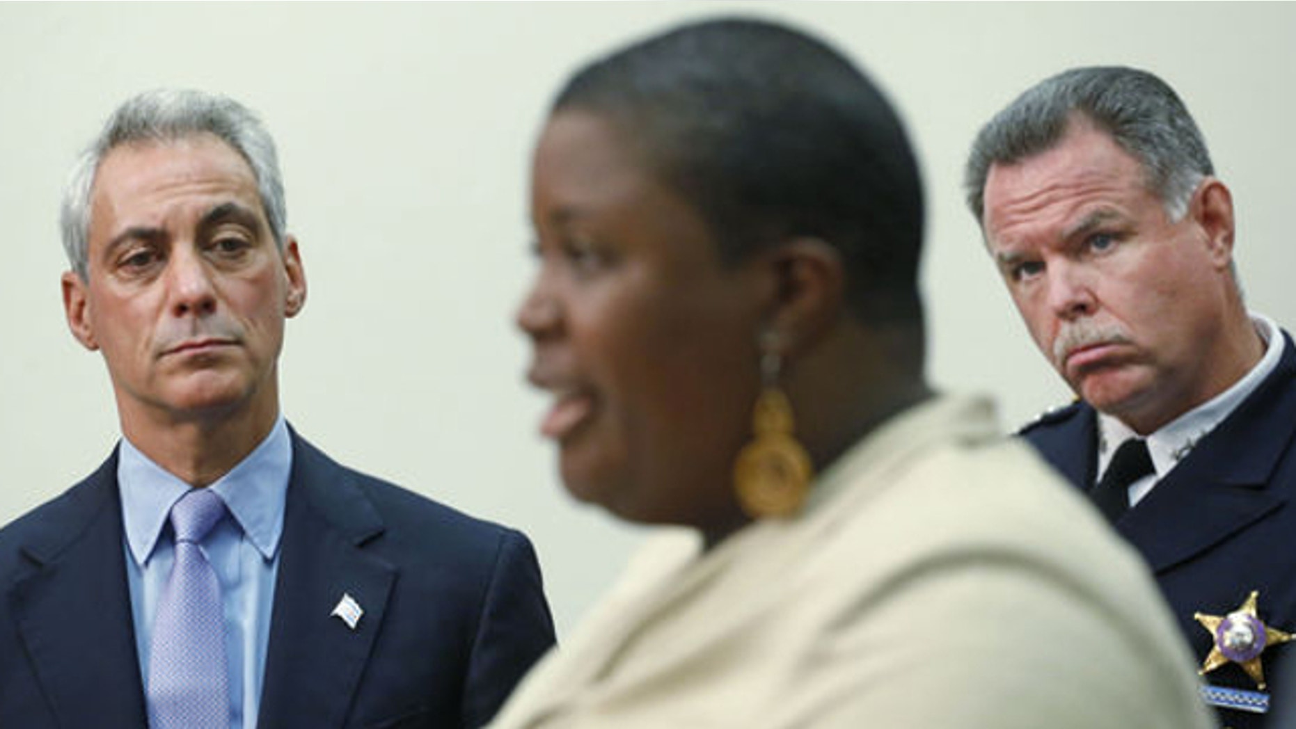 Oct. 15, 2013: Chicago Mayor Rahm Emanuel, and Police Superintendent Garry McCarthy listen as Cleopatra Pendleton, the mother of slain teen Hayida Pendelton speaks at a news conference in Chicago.