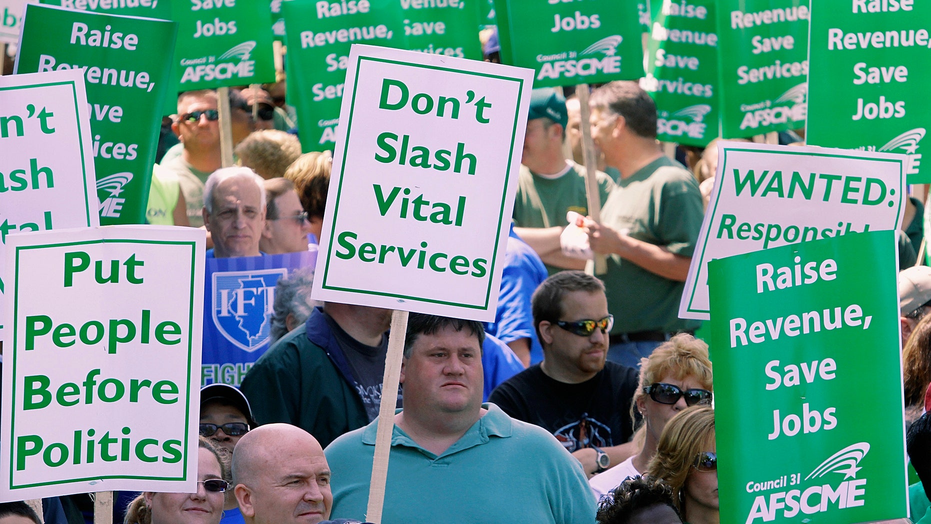 FILE: In this April 21, 2010, file photo, thousands of people, including state union members, state workers, teachers and social service organizations rally to protest budget cuts at the Illinois State Capitol in Springfield, Ill.