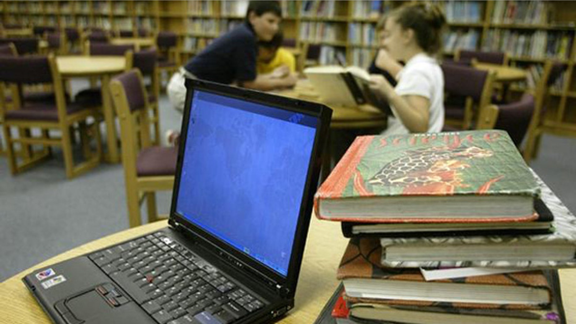 ** FILE ** An IBM ThinkPad computer, left, is shown next to a stack of text books that is issued to the typical fifth-grade at Johnson Elementary School, in Forney, Texas, in this , April 28, 2004, file photo. International Business Machines Corp. has reportedly put its personal computer business up for sale in a deal that could fetch as much as $2 billion and close an era for an industry pioneer that long ago shifted its focus to more lucrative segments of the computer business. (AP Photo/stf/Donna McWilliam)