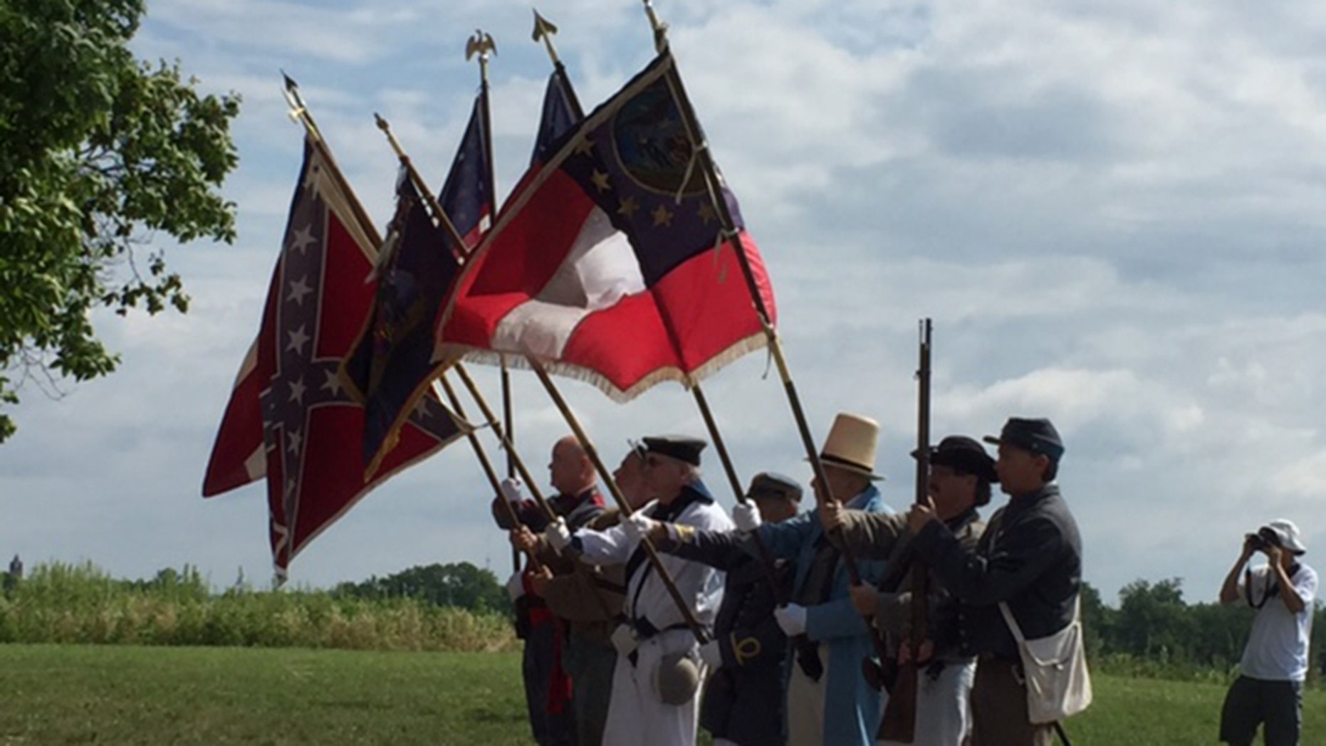 A group of reenactors march in formation from the North Carolina Memorial along West Confederate Ave to the Virginia Memorial at Gettysburg.