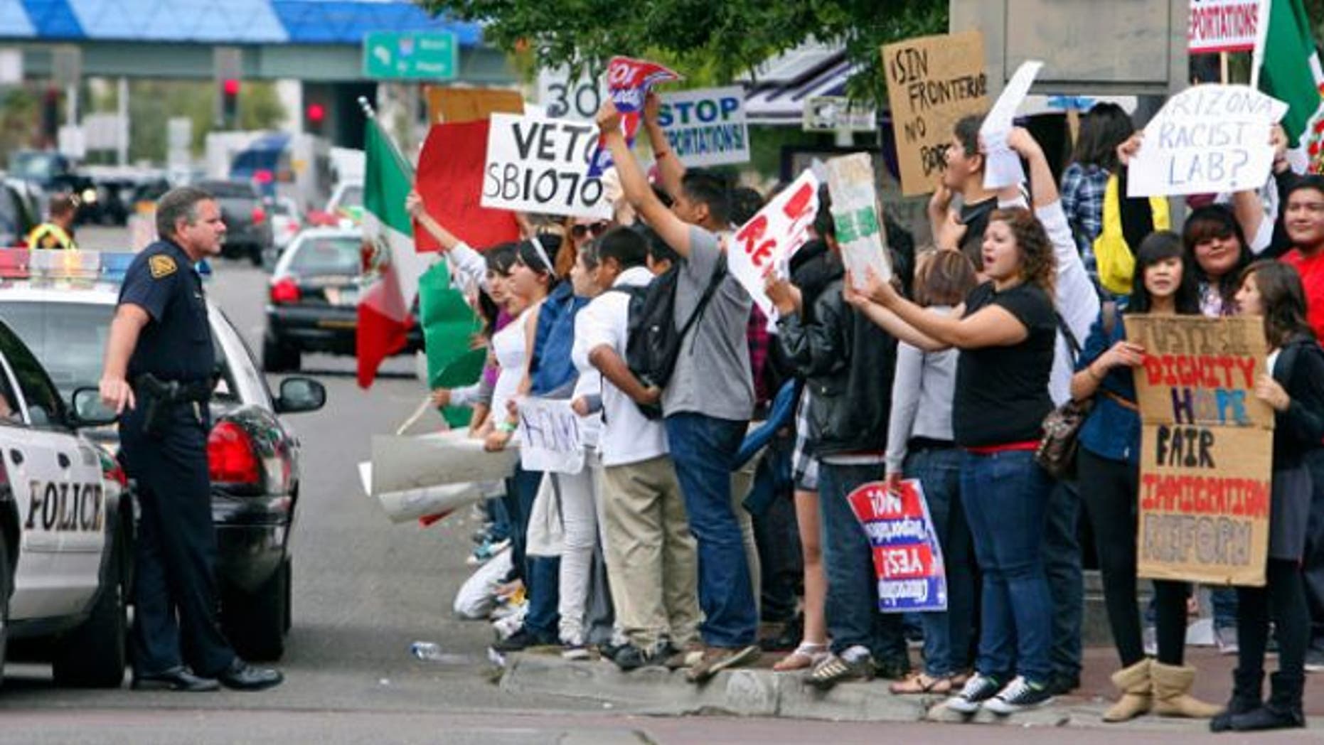 FILE: Hundreds of protesters rally against Arizona's immigration law in Tucson.