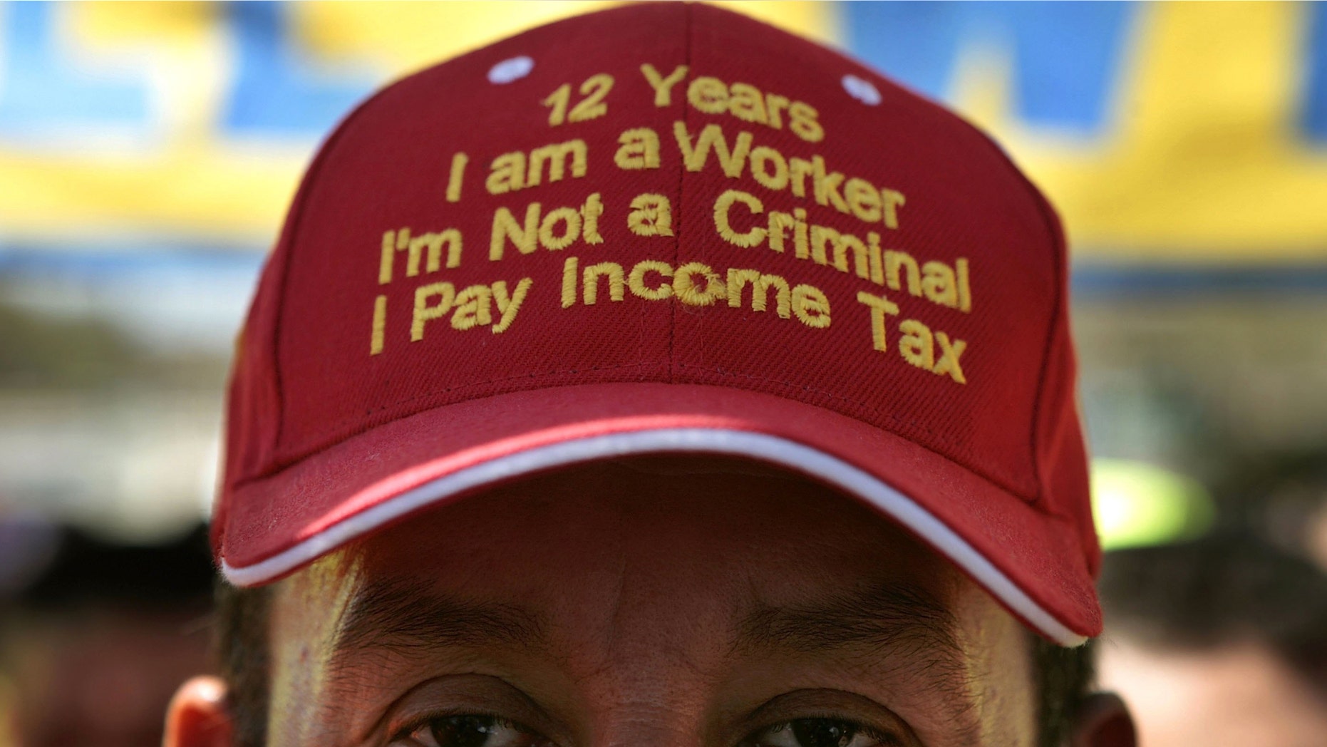 Colombian immigrant Edgar Duque of Union City, New Jersey, wears a hat that reads, "12 Years, I am a Worker, I'm Not a Criminal, I Pay Income Tax" (Photo by Chip Somodevilla/Getty Images)
