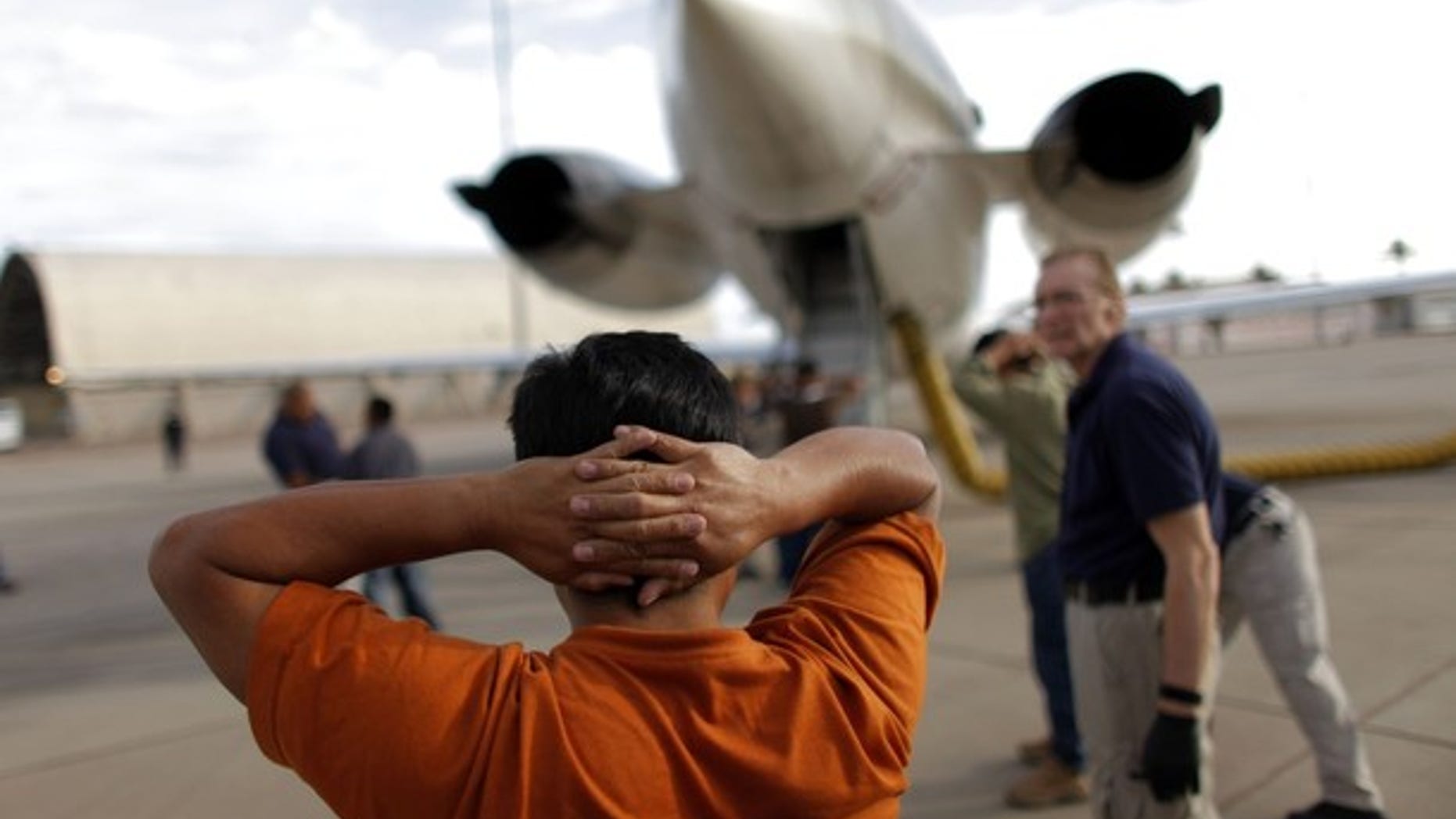 July 10, 2009: A Guatemalan illegal immigrant prepares to board a plane at the Phoenix-Mesa Gateway airport during his deportation process.