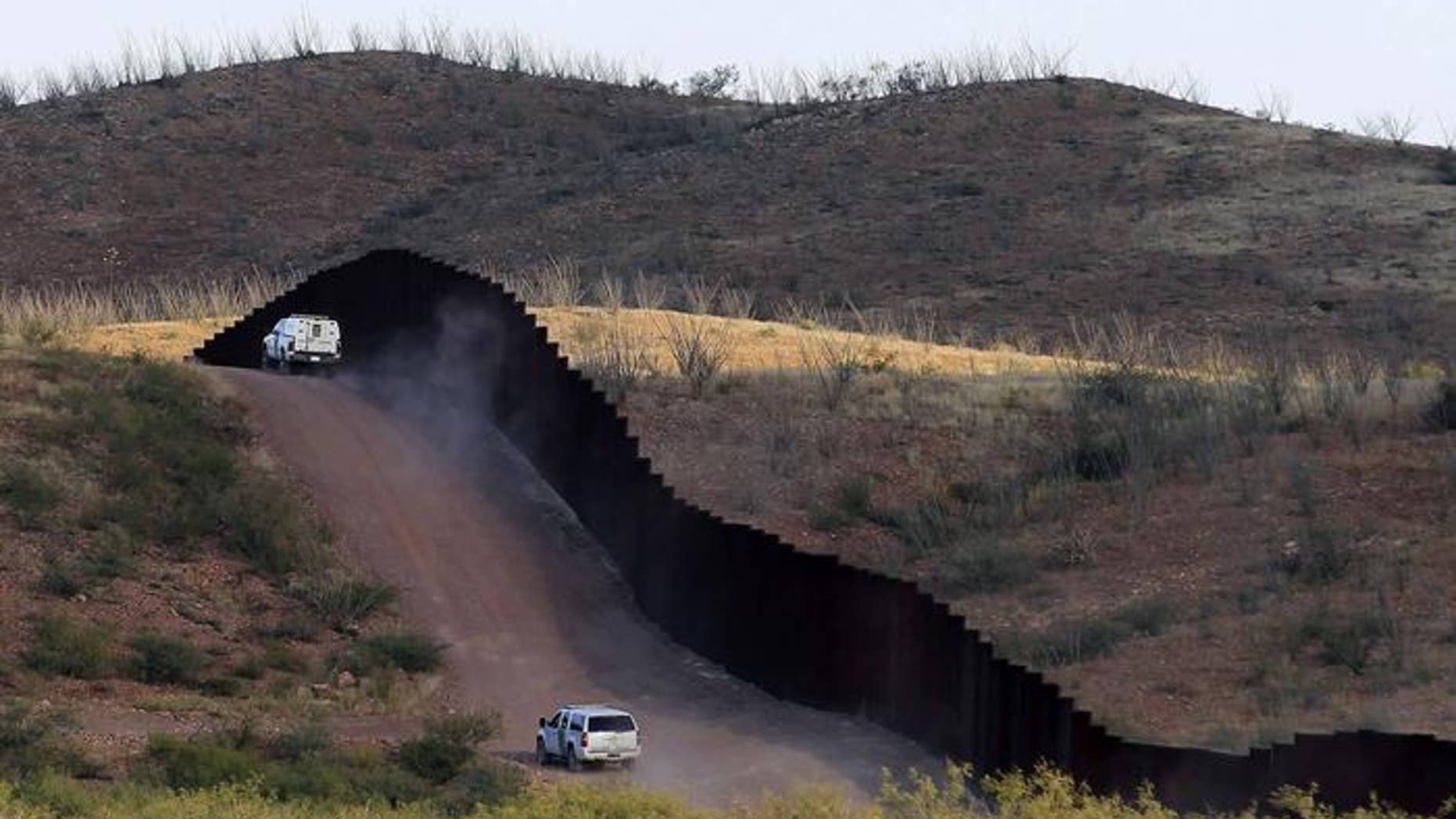U.S. Border Patrol agents patrolling the border fence near Naco, Ariz.