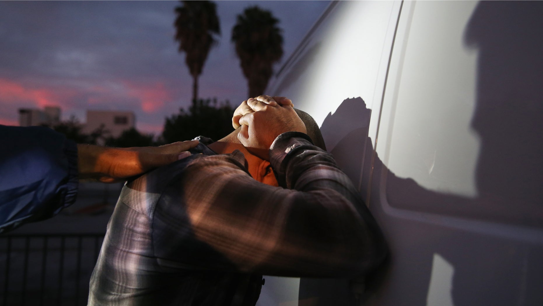 A man is detained by Immigration and Customs Enforcement (ICE), agents early on October 14, 2015 in Los Angeles, California. (Photo by John Moore/Getty Images)