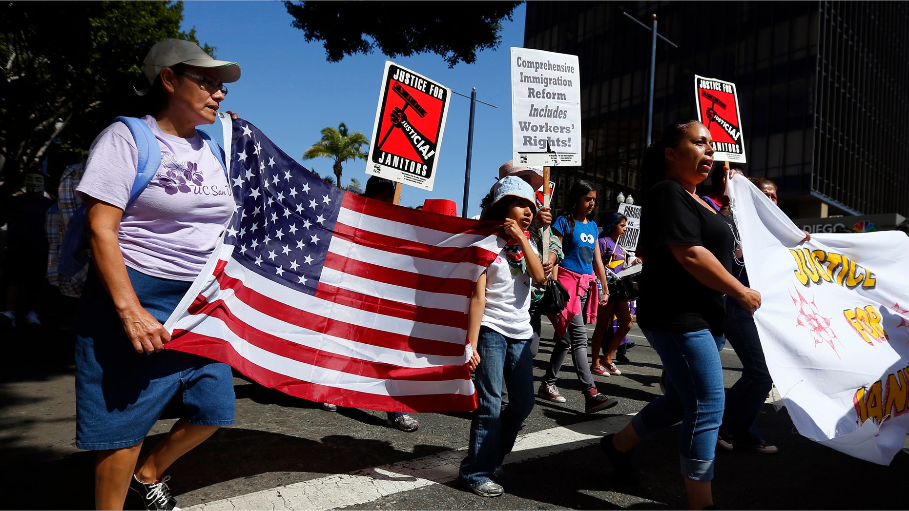 People march through the streets during a May Day demonstration in San Diego, California May 1, 2013.