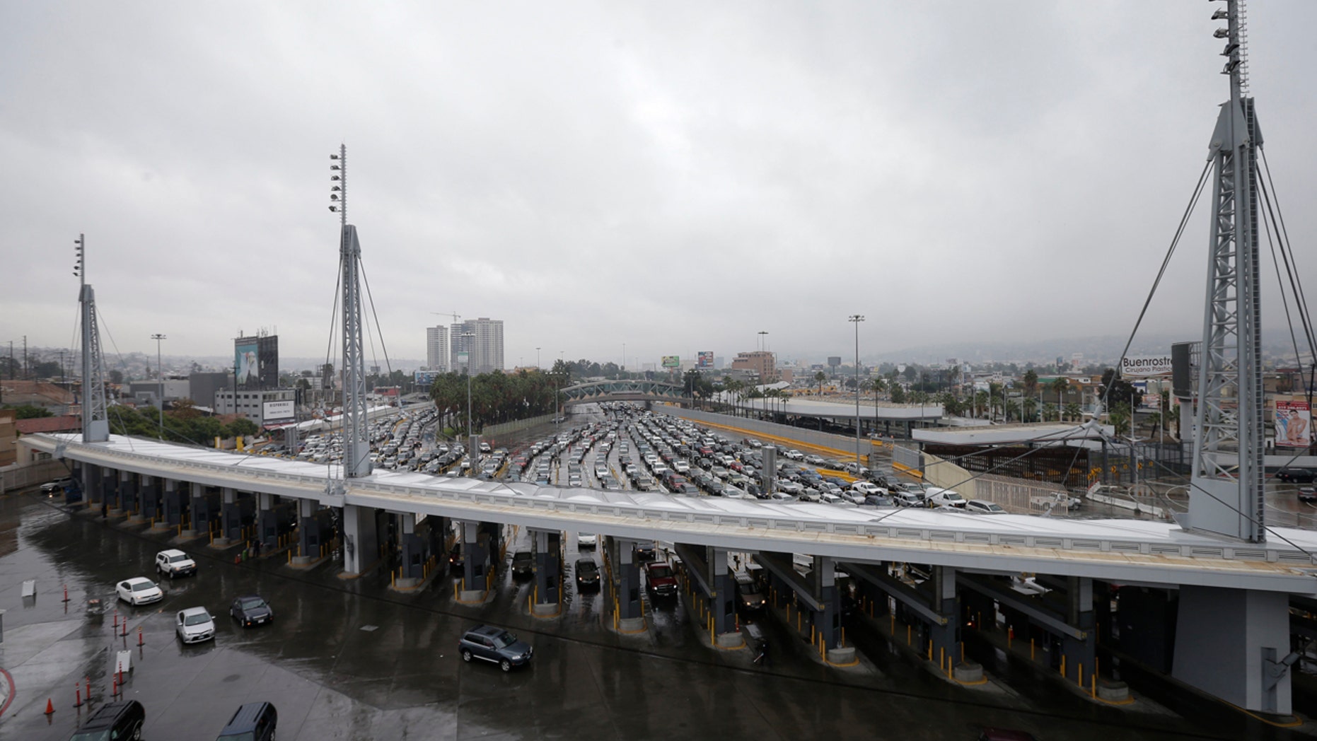 FILE - In this Dec. 3, 2014, file photo, cars wait to enter the United States from Tijuana, Mexico, through the San Ysidro port of entry in San Diego.