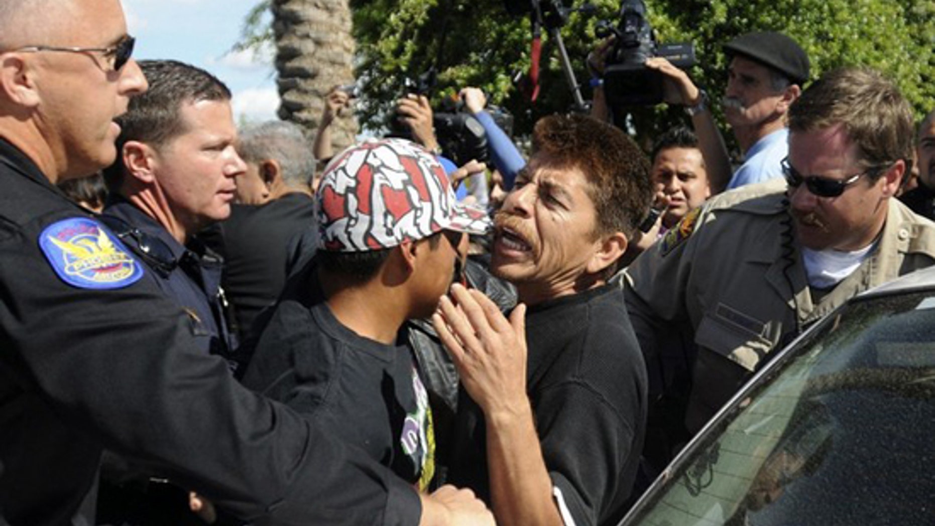 Protesters interact with police during a demonstration outside the Arizona State Capitol in Phoenix, Arizona, April 23, 2010 in protest of an immigration law signed by Arizona Governor Jan Brewer. (Reuters)