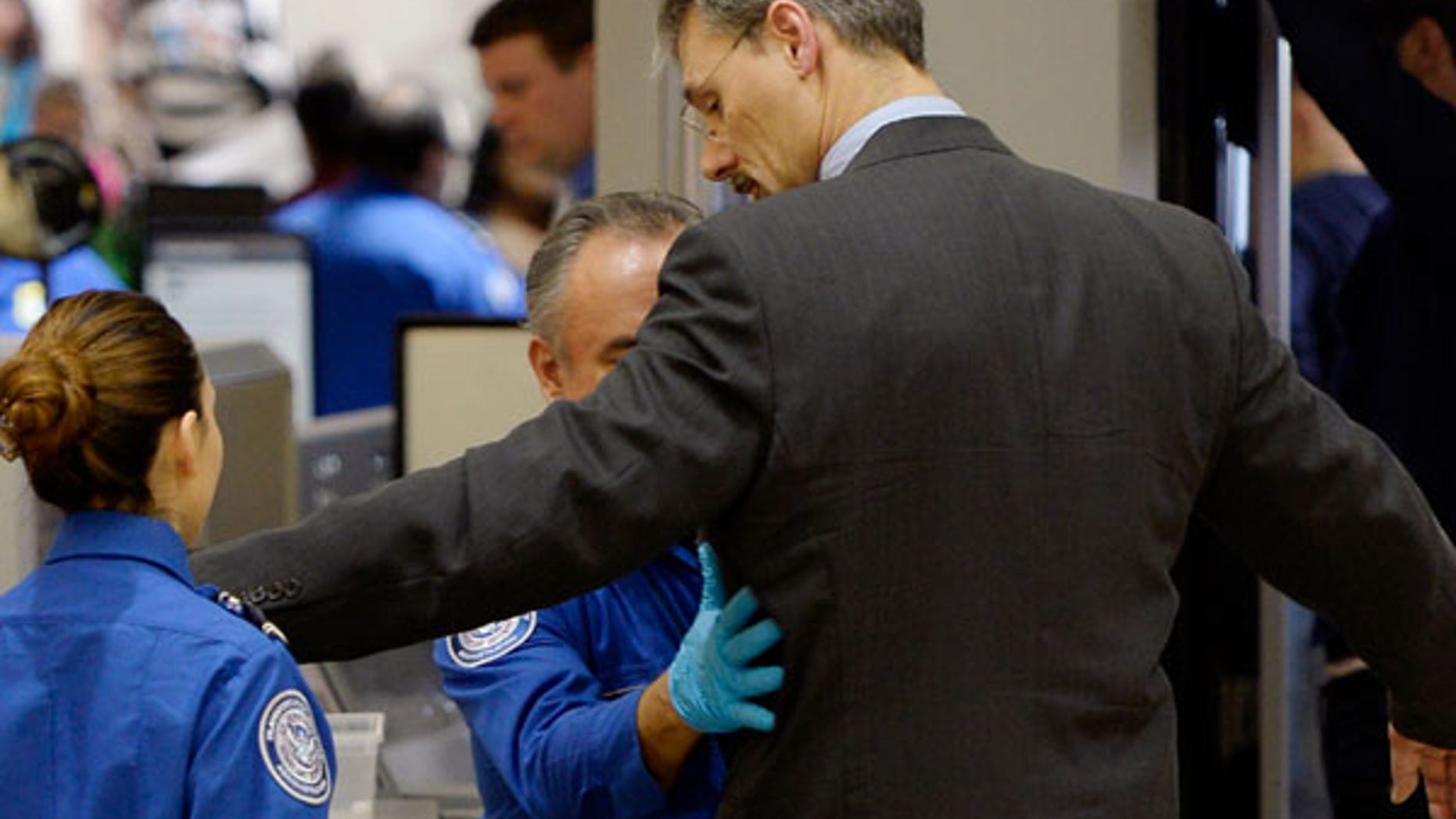 FILE: TSA agents pat-down a passenger at Los Angeles international Airport.