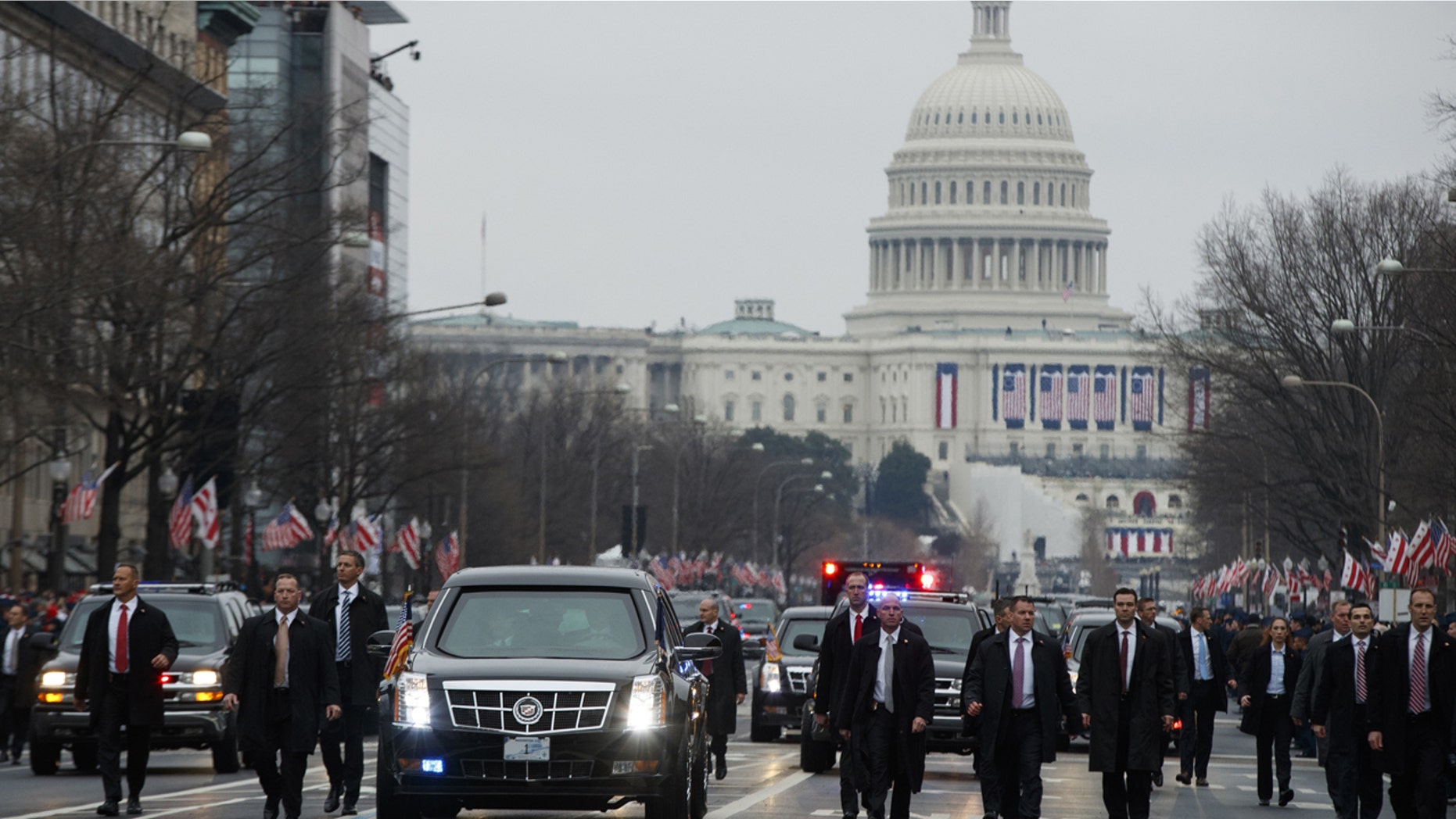 Secret Service agents escort President Donald Trump's vehicle along the inauguration day parade route after he was sworn in as the 45th President of the United States, Friday, Jan. 20, 2017, in Washington.