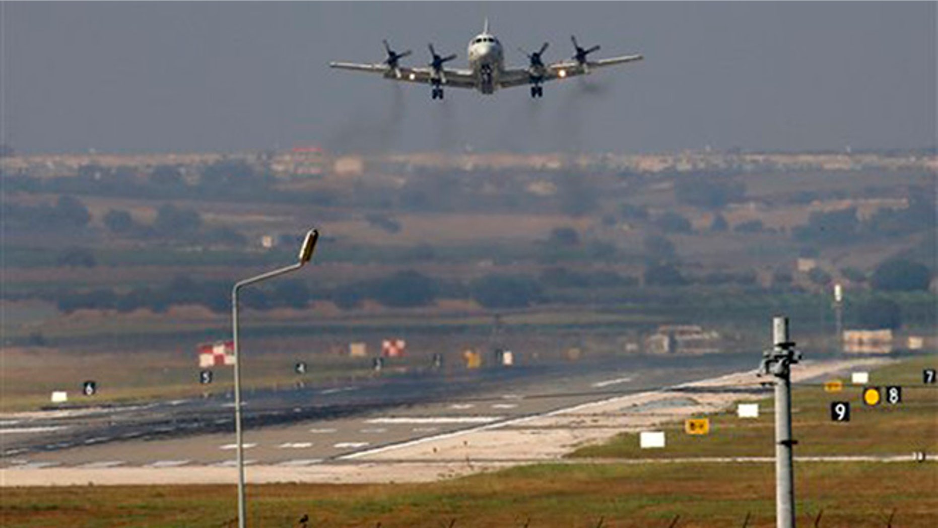 A United States Navy plane approaches to land at the Incirlik Air Base, in Adana, in the outskirts of the city of Adana, southeastern Turkey, Tuesday, July 28, 2015.