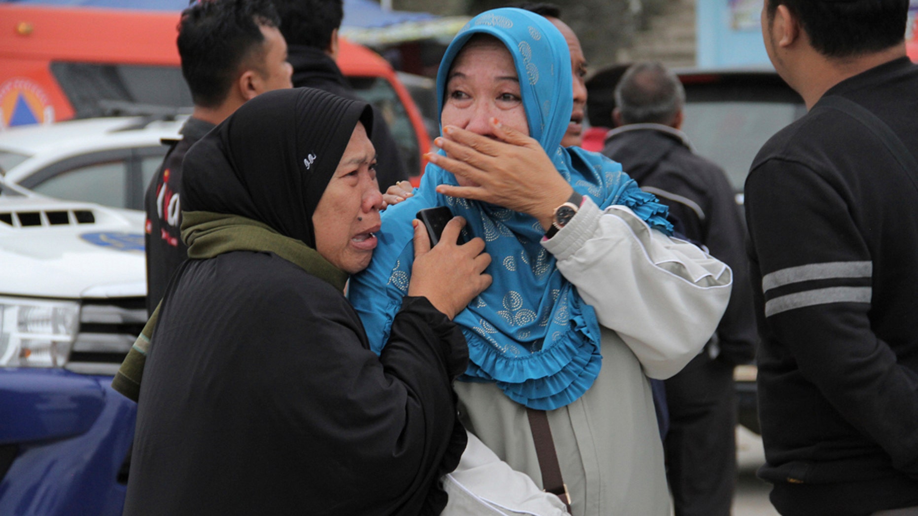 Relatives weep at Tigaras port after learning that their family members are among the passengers of a ferry which sank on Monday, in Simalungun, North Sumatera, Indonesia, Tuesday, June 19, 2018.