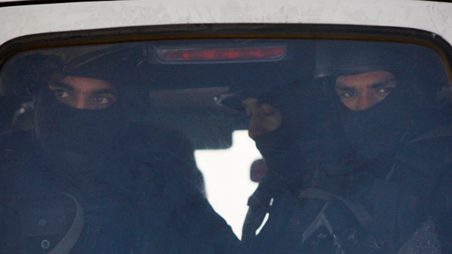 Jan. 5, 2016: Indian military commandos look from inside a vehicle at the Indian air force base in Pathankot, India.