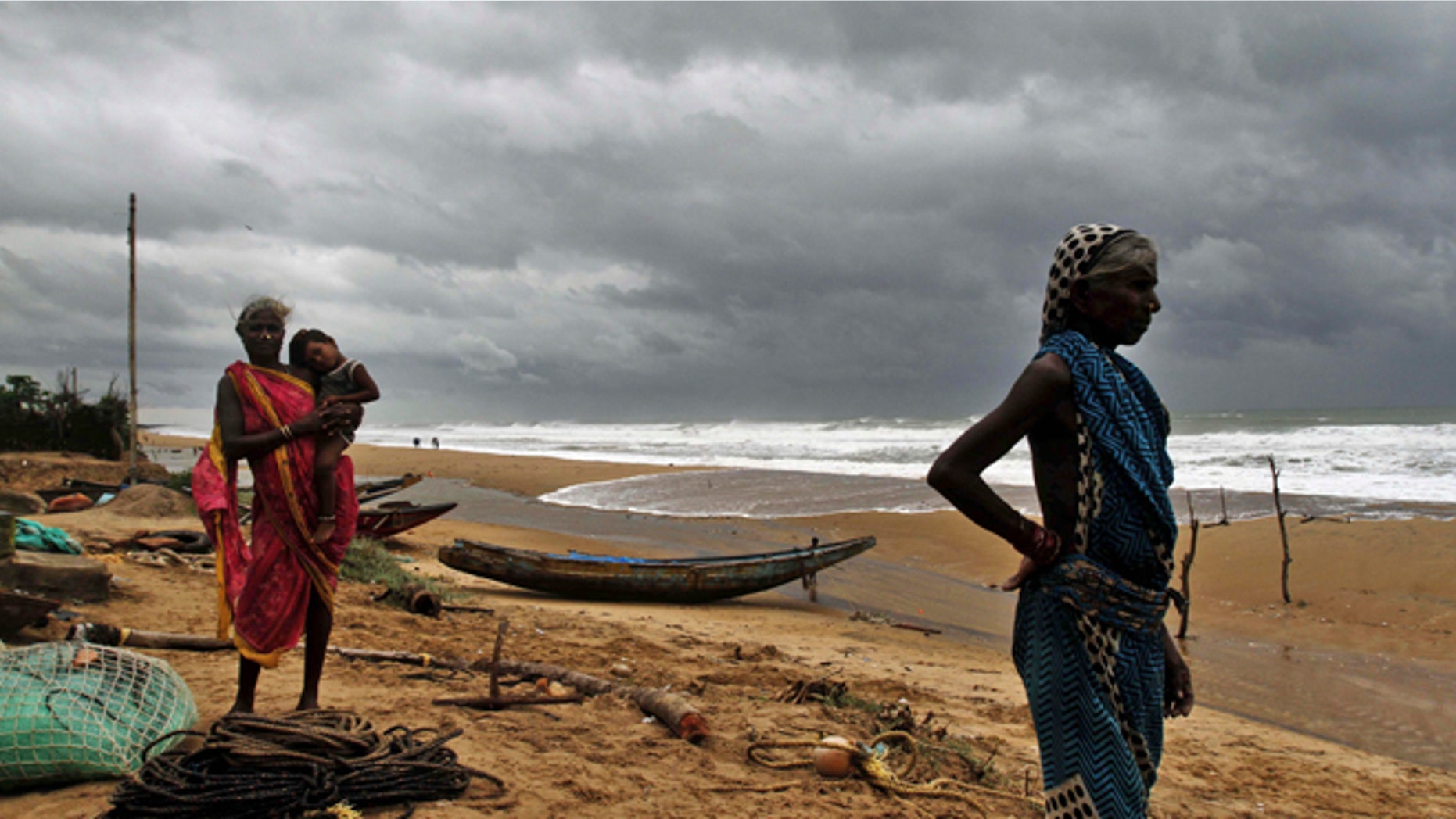 Oct. 11, 2014: Fisherwomen watch the sea waves before evacuating the place near Podampeta village, on the outskirts of Gopalpur beach in Ganjam district, 140 kilometers (87 miles) south of Bhubaneswar, India.