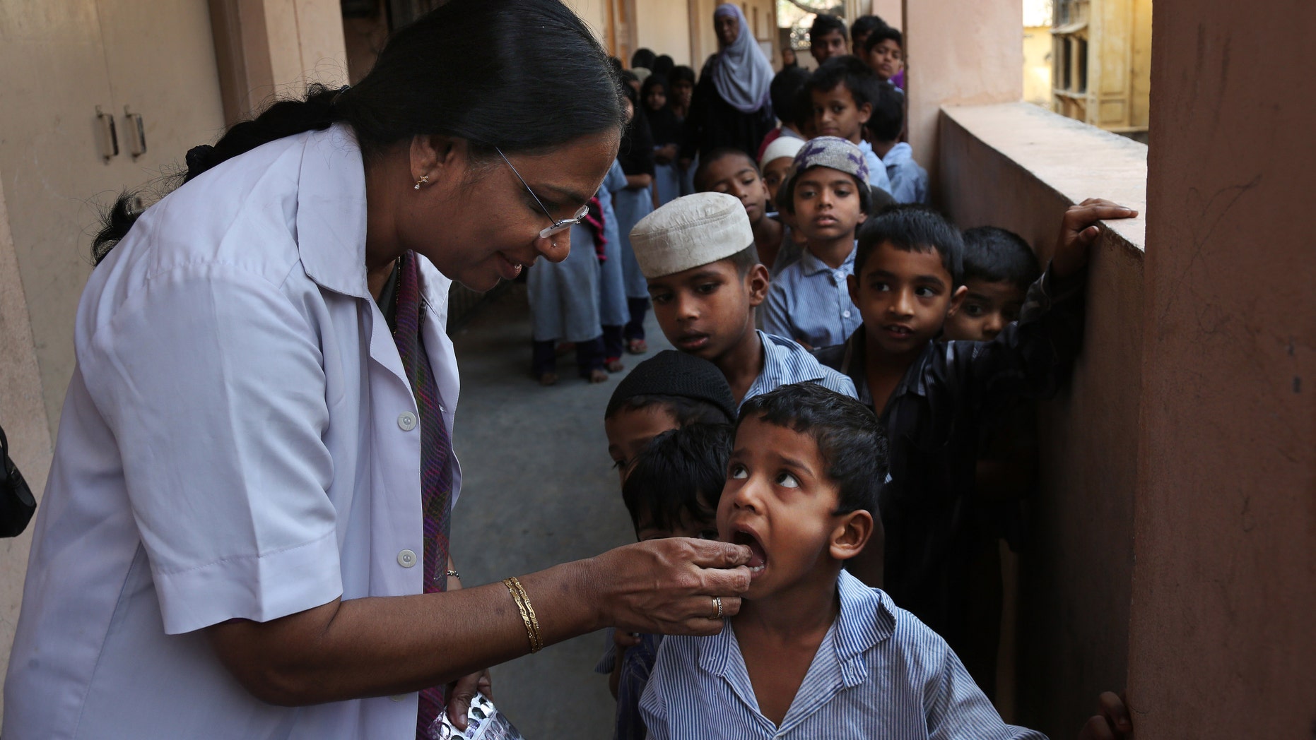 Feb. 10, 2016: Indian schoolchildren line up to take a deworming tablet in Hyderabad, India.