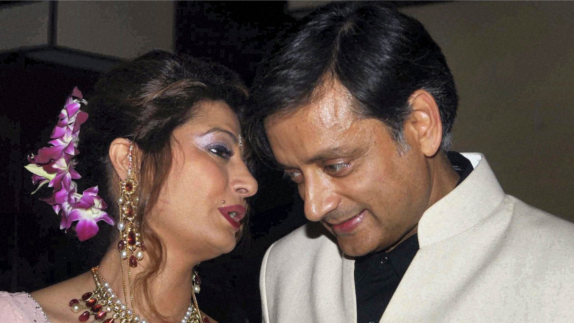 Sept. 4, 2010: Former Indian Junior Foreign Minister Shashi Tharoor listens to his wife Sunanda Pushkar at their wedding reception in New Delhi, India