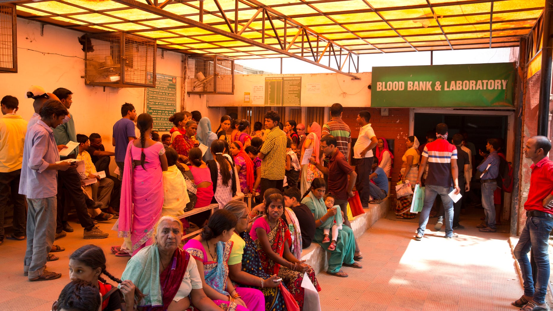 In this Tuesday, Sept. 27, 2016 photo, people wait to receive reports of their blood samples given to test mosquito-borne viral ailments, in Gurgaon, on the outskirts of New Delhi, India. The hospitals of New Delhi are crowded with patients writhing in pain as yet another round of mosquito-borne viral ailments sweep through this teeming city. It's a cycle that's played out every year after the monsoon rains have filled puddles and open drains and the warm, damp weather is perfectly suited for swarms of mosquitoes. (AP Photo/Manish Swarup)