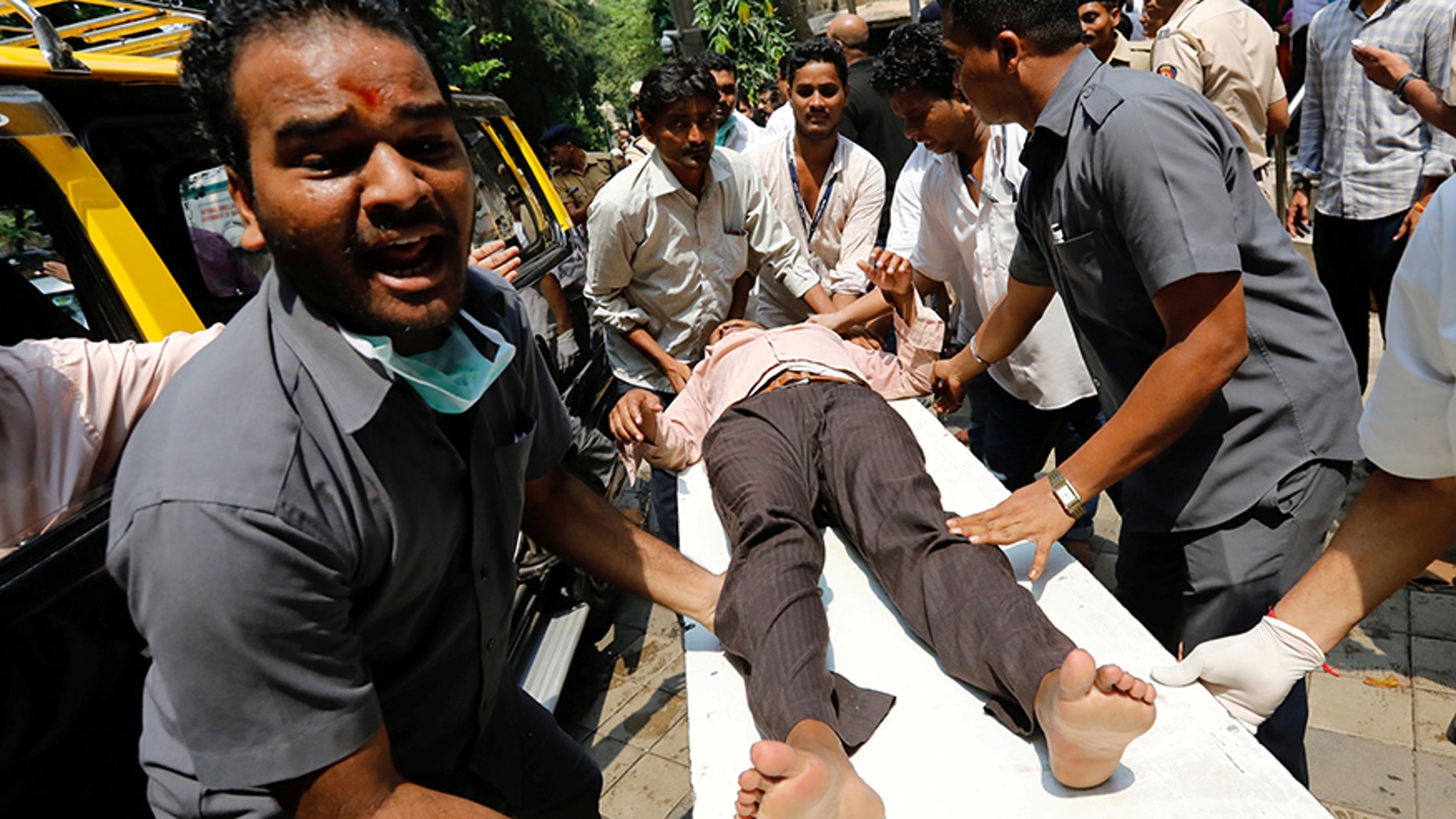 Sept. 29, 2017: A stampede victim is carried on a stretcher at a hospital in Mumbai, India.