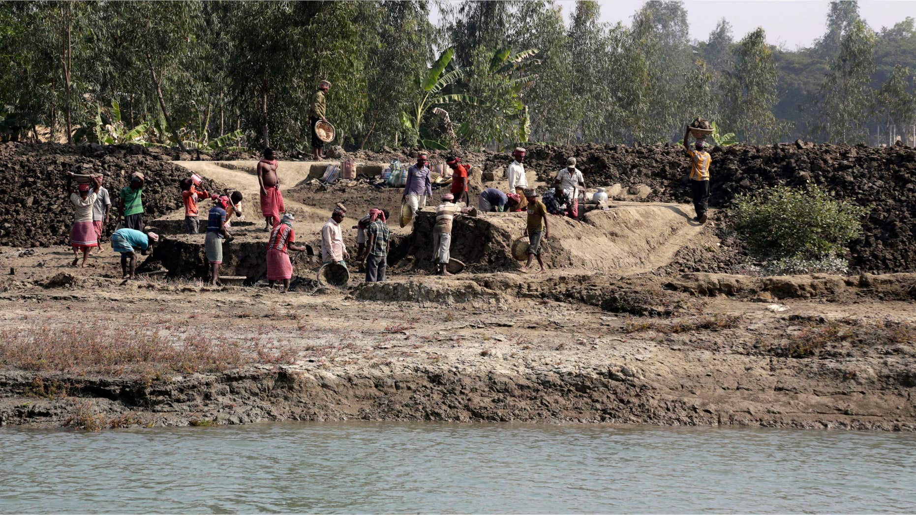 Feb. 2, 2015: Laborers work at an embankment under construction near Sonaga village in the Sundarbans, India.